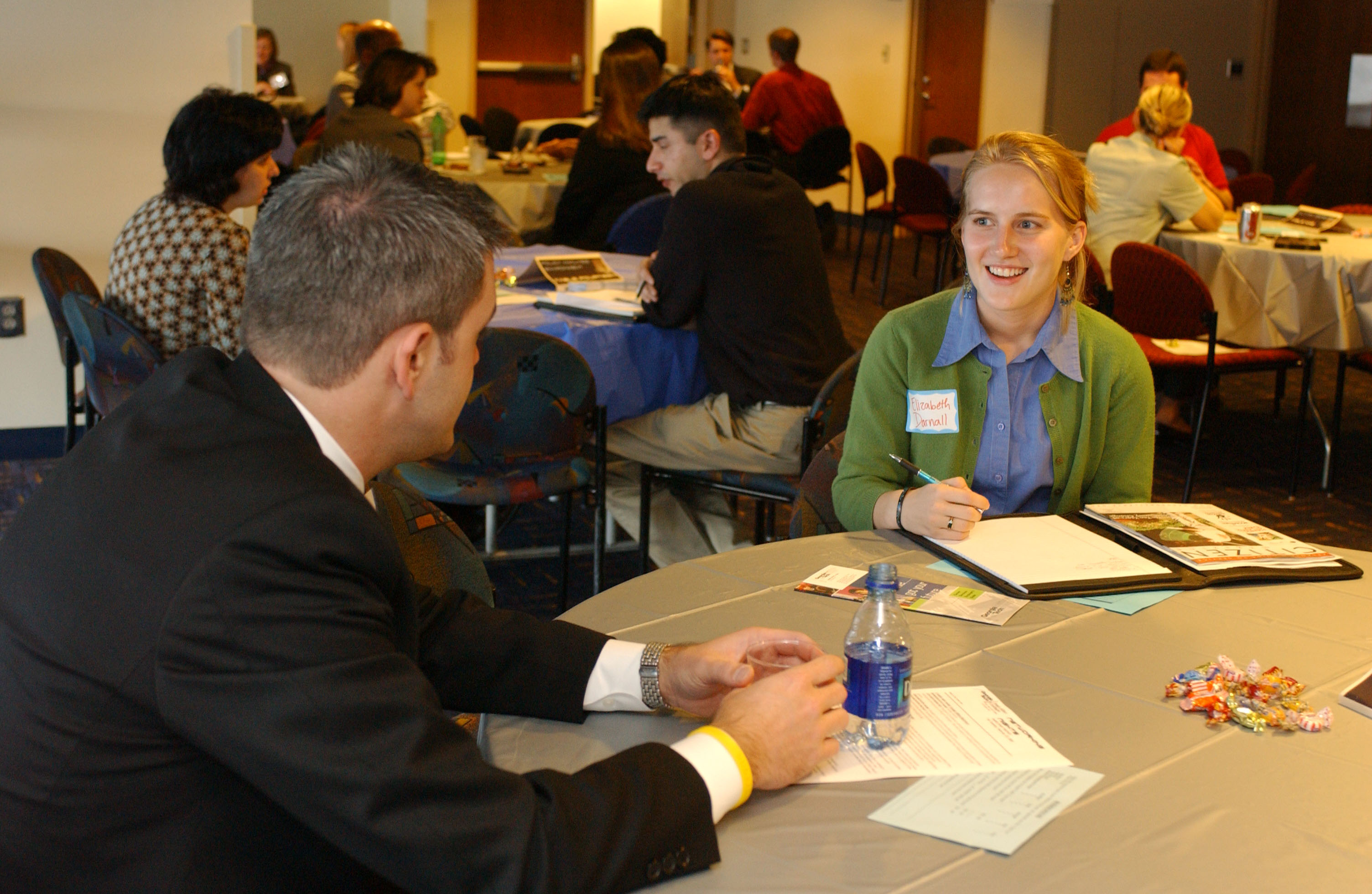 A student talks with a recruiter at a career event. 
