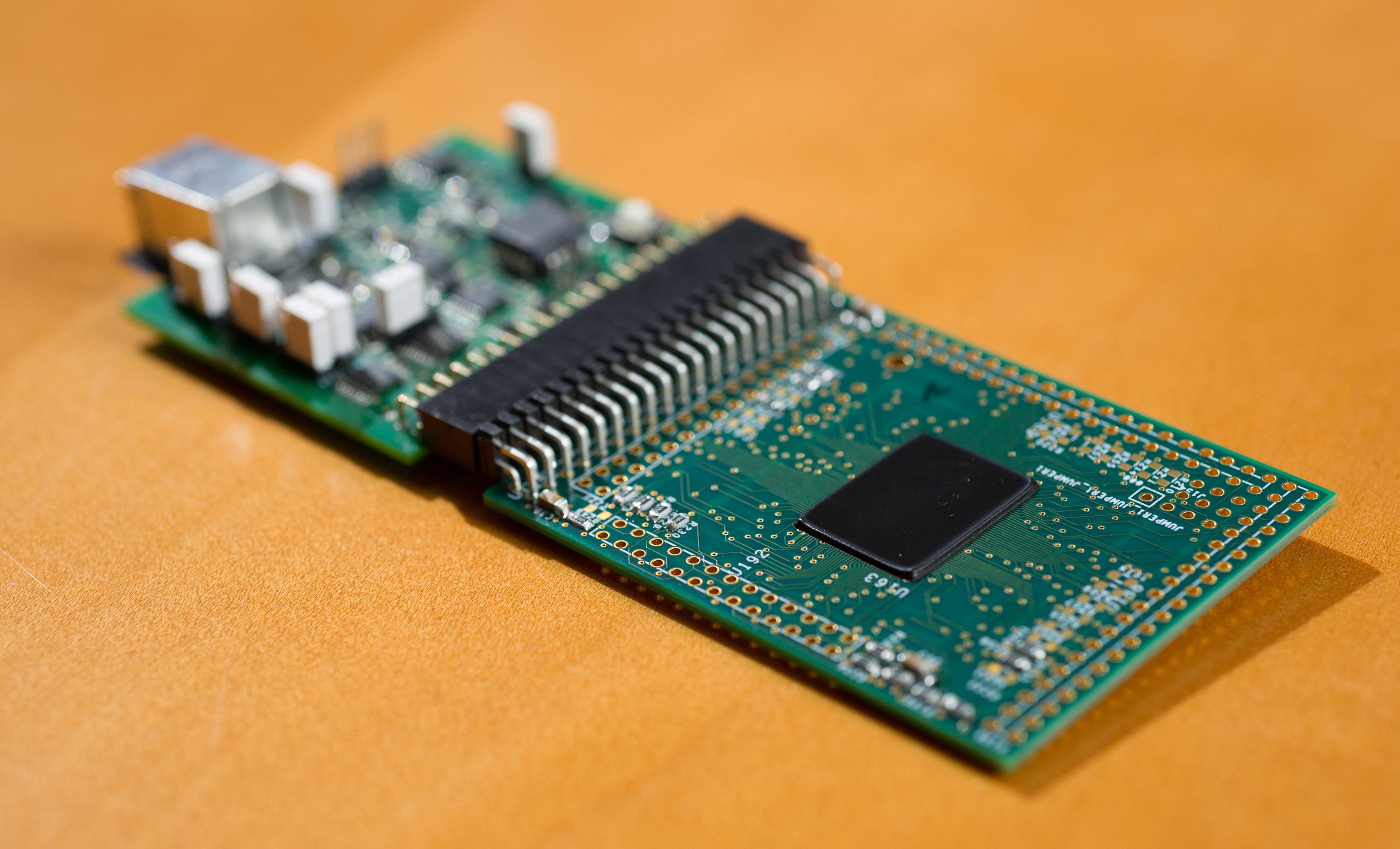 Close-up of a field programmable analog array (FPAA) board, developed by professor Jennifer Hasler, that includes an integrated circuit with biological-based neuron structures for power-efficient calculation. Hasler’s research indicates that this type of board, which is programmable but has low power requirements, could play an important role in advancing neuromorphic computing. (Georgia Tech Photo: Rob Felt)