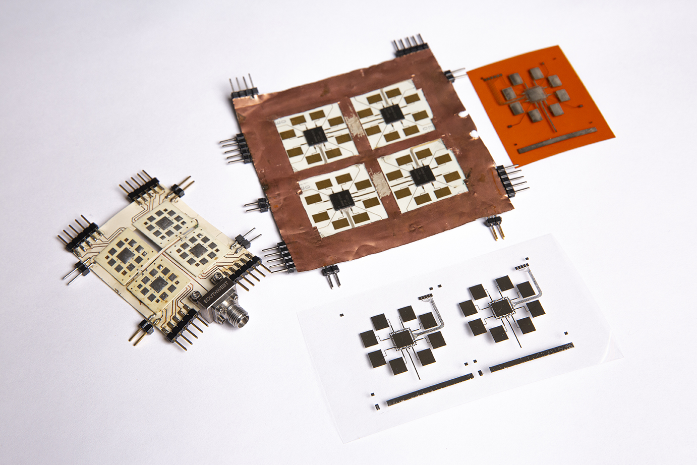 Two fabricated proof-of-concept tile are shown alongside two inkjet-printed tile arrays, which the team will present on at the upcoming International Microwave Symposium in June.