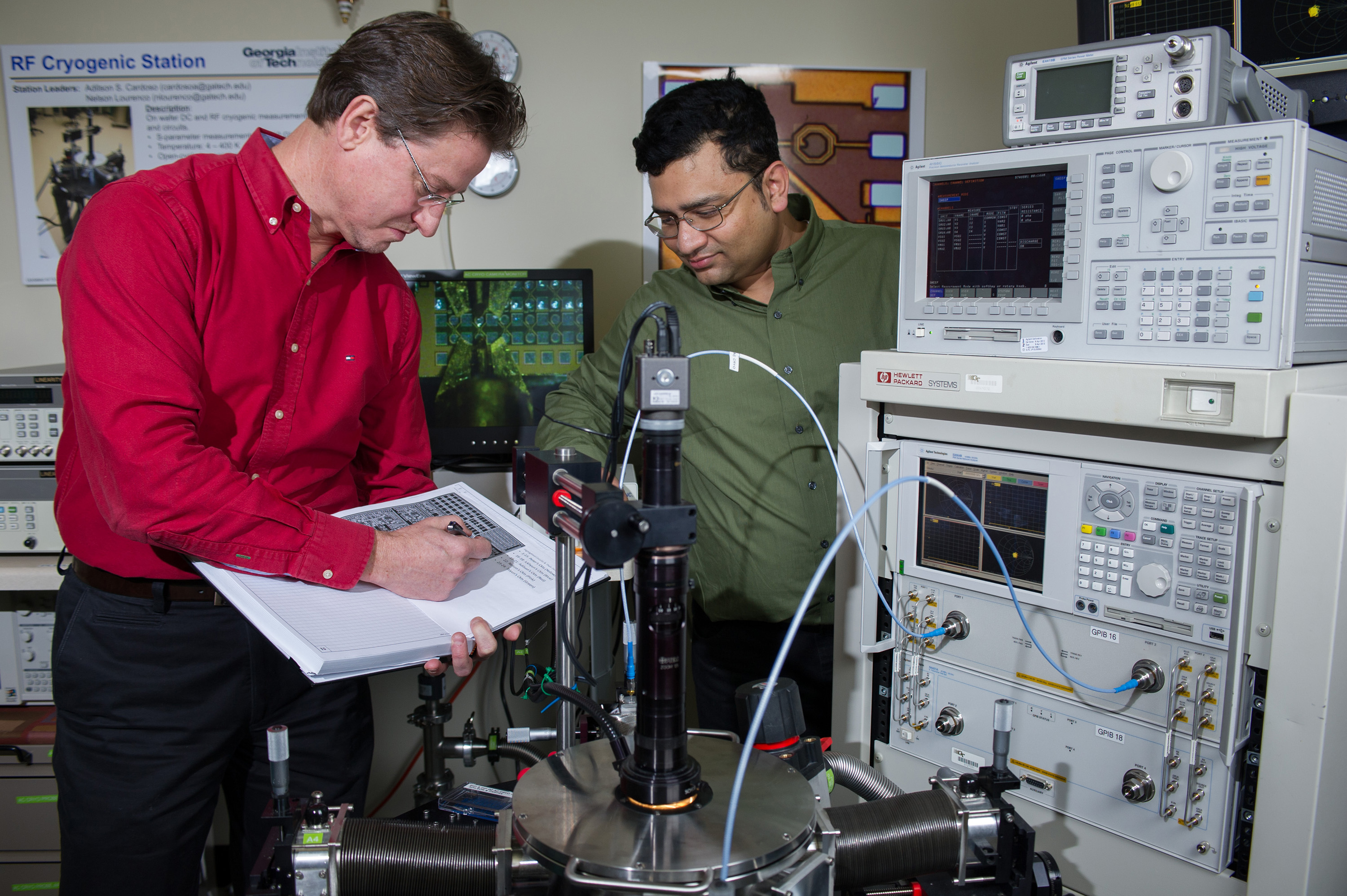 Professor John Cressler (left) and graduate student Partha Chakraborty confer at a cryogenic probe station at Georgia Tech. (Georgia Tech Photo: Rob Felt)