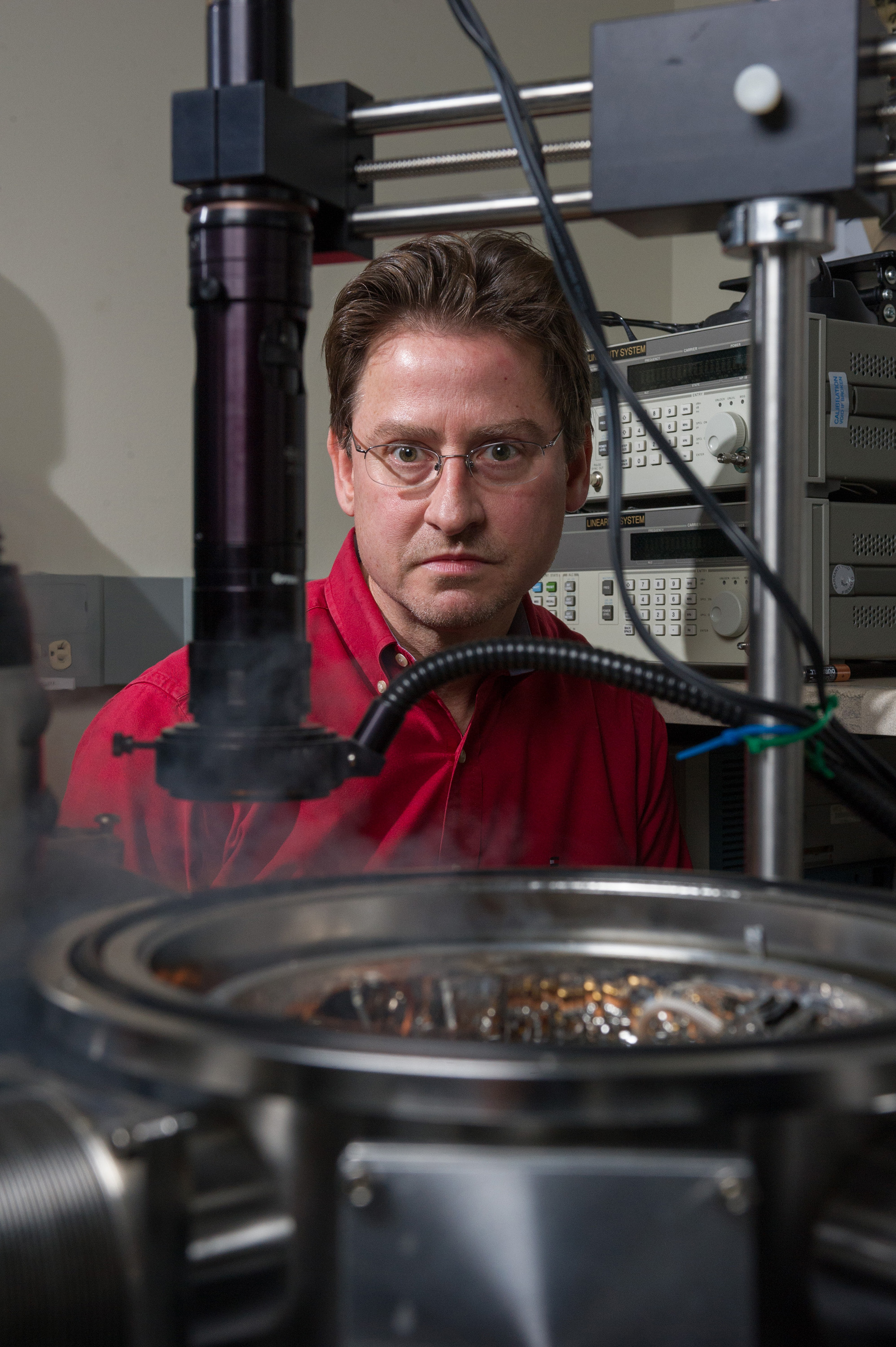 Professor John Cressler is pictured here with a cryogenic probe station in a Georgia Tech laboratory. A cloud produced by boiling liquid nitrogen can be seen in the foreground. (Georgia Tech Photo: Rob Felt)