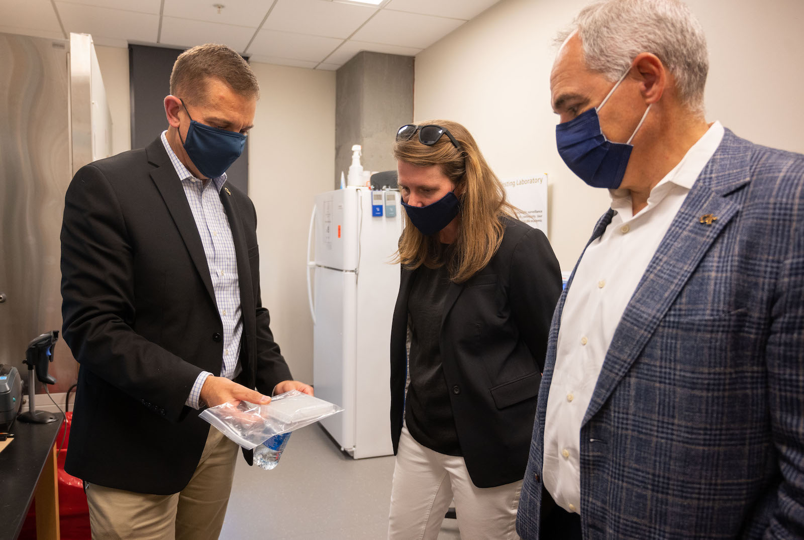 Teresa MacCartney, acting chancellor of the USG (center), tours the Covid-19 testing lab with Mike Shannon, a principal research engineer from GTRI who manages the overall Covid-19 testing program, and President Ángel Cabrera. (Photo by Allison Carter)