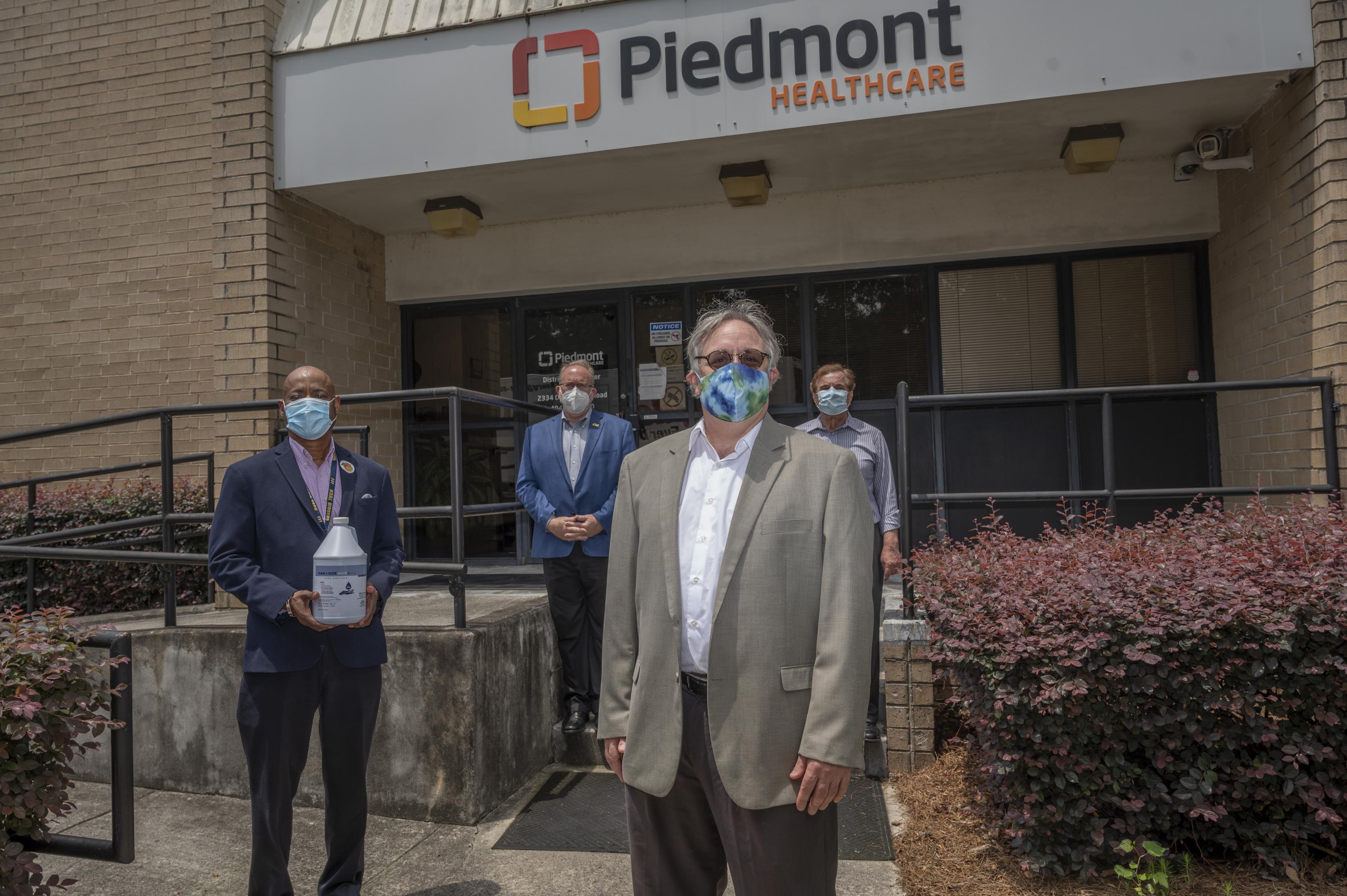 The heroes who redesigned hand sanitizer and donated 7,000 gallons of their own brand to hospitals and nursing homes. From left to right: George White, Chris Luettgen, Seth Marder, and Atif Dabdoub. Here at a delivery to Piedmont Healthcare of Atlanta. Credit: Georgia Tech / Christopher Moore