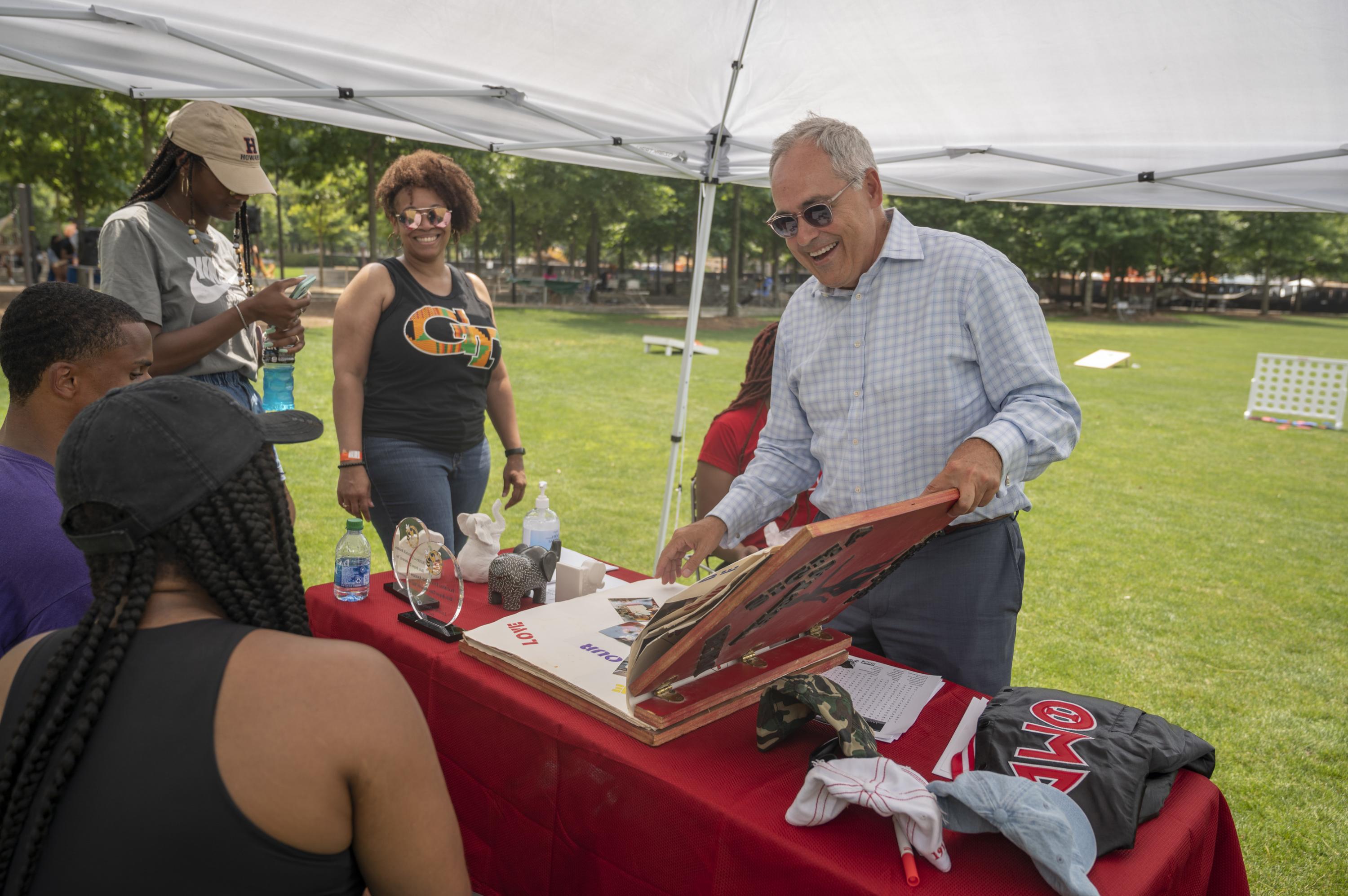 President Ángel Cabrera visits Delta Sigma Theta sorority's table at OMED's Juneteenth celebration on Tech Green