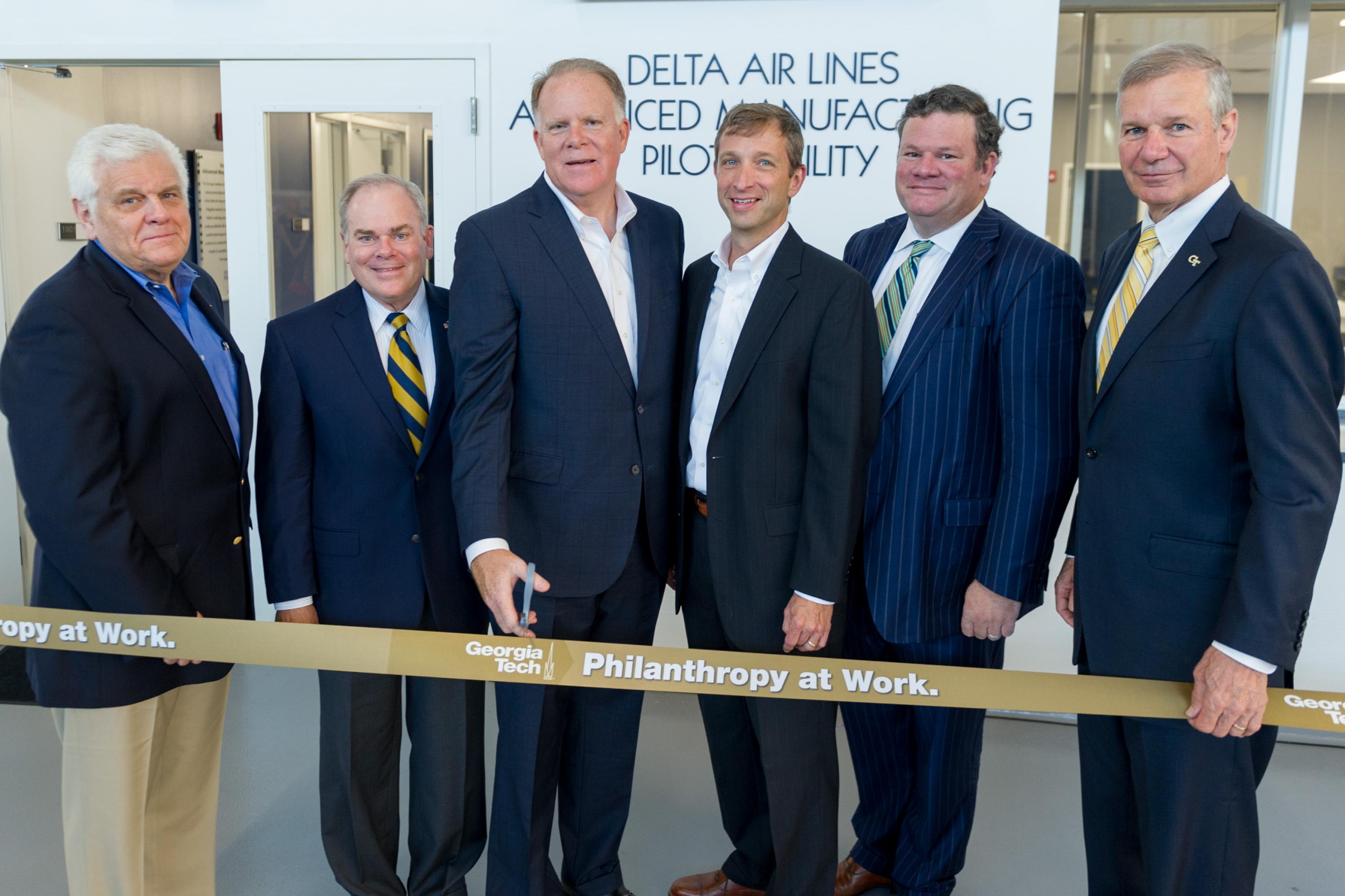 From left, Don McConnell, Georgia Tech vice president of Industry Collaboration; Steve Cross, Georgia Tech executive vice president for Research, Gil West, Delta’s senior executive vice president and chief operating officer, David Garrison, senior vice president for Engineering, Quality, Planning and Logistics for Delta; Tad Hutcheson, senior vice president of the Delta Air Lines Foundation; and Georgia Tech President G.P. “Bud” Peterson cut the ribbon on the new Delta Air Lines Advanced Manufacturing