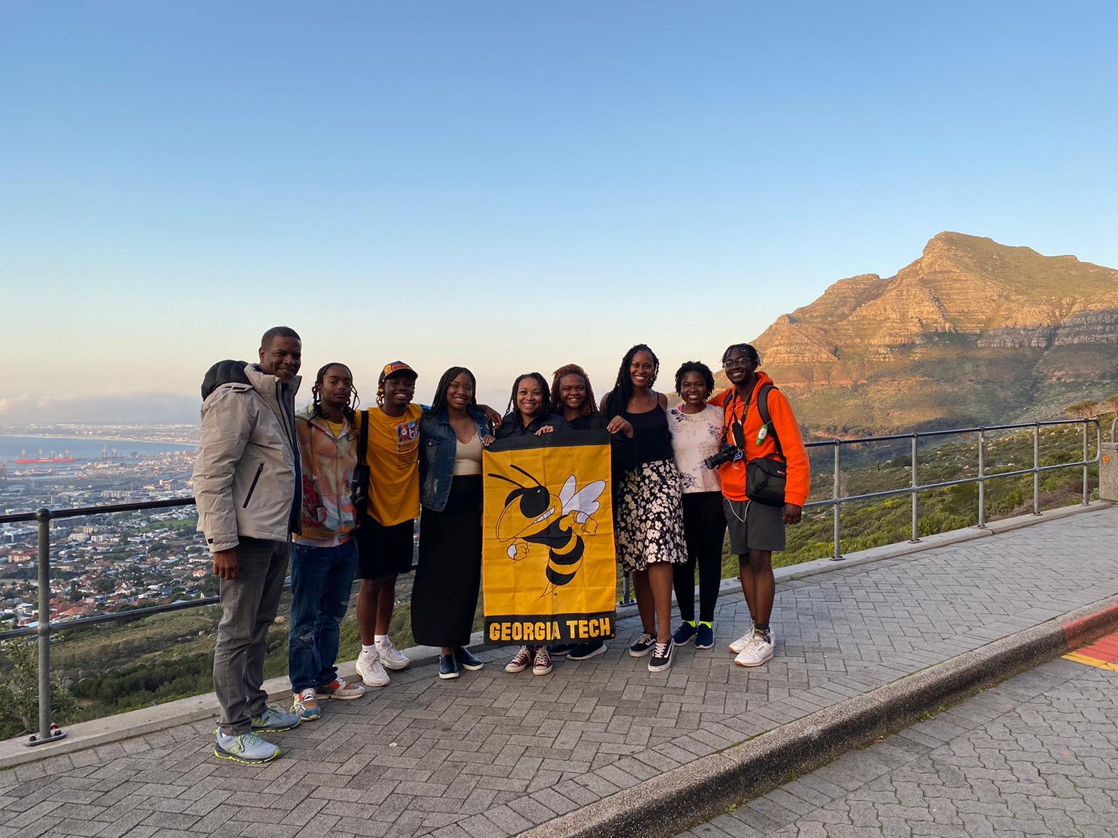 Students and staff with OMED’s Study Abroad and Global Innovation Project after going to the top of Table Mountain, overlooking the city of Cape Town in South Africa.