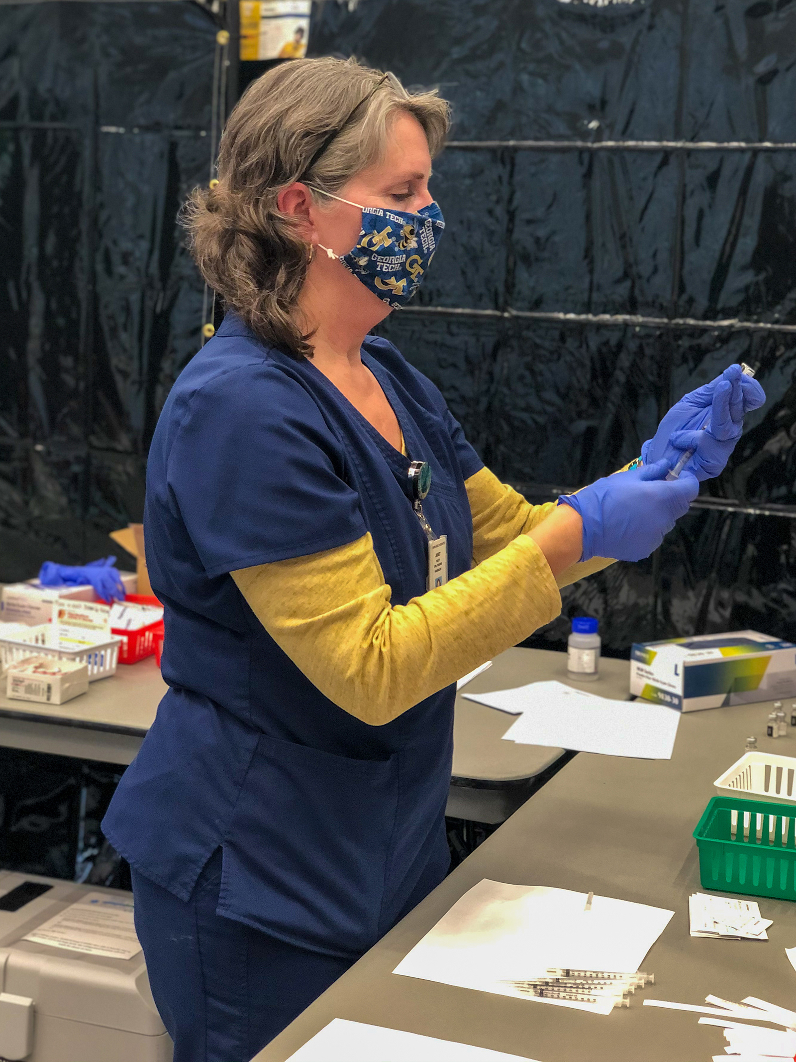 Janet Foley, a pharmacist with Stamps Health Services, is working at the Covid-19 vaccine distribution clinic in the Exhibition Hall. (Photo by Evan Atkinson)