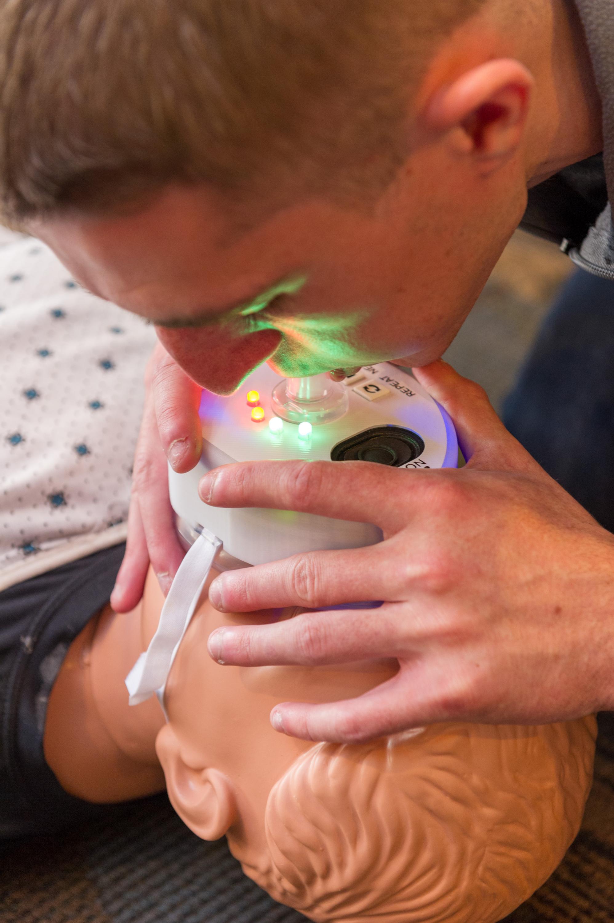 CPR+ is a CPR mask with LED lights that offers user feedback throughout the resuscitation process. The device is one of six inventions is competing for Georgia Tech’s 2017 InVenture Prize.

Ryan Williams, a computer engineering major, demonstrates delivering rescue breaths with the device. When done correctly the lights turn green.

The other inventors are: Dave Ehrlich, a computer engineering major, and Samuel Clarke, a mechanical engineering and computer science major.

Photo by Rob Felt. 