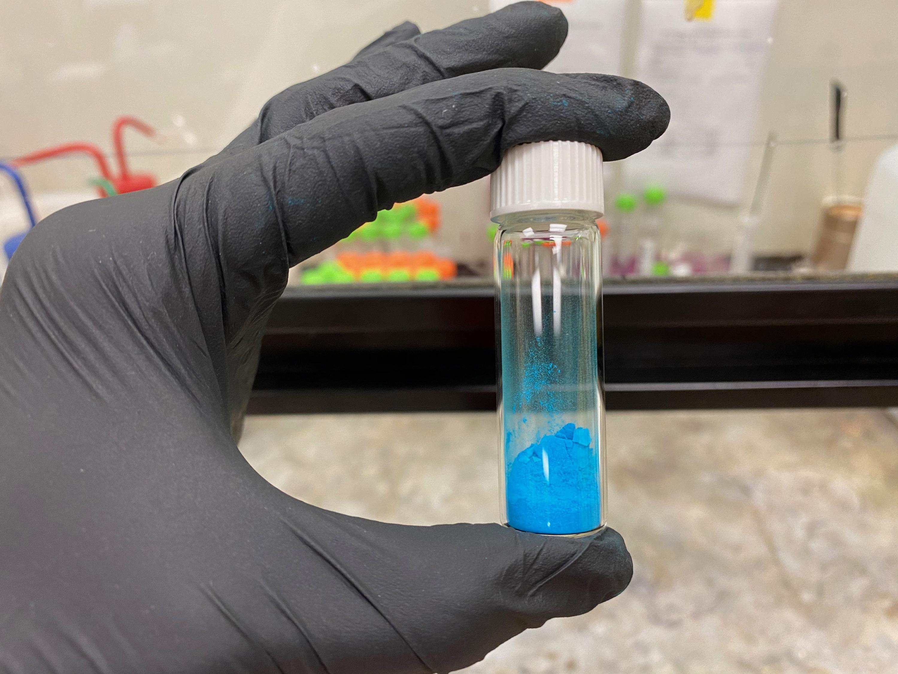 The vial shown contains a blue powder, HKUST-1, a metal-organic framework (MOF) material. (Credit, Tania Evans, Georgia Tech)