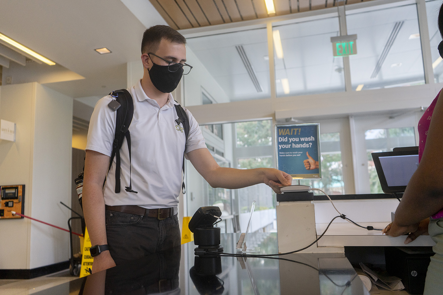 Student wearing a mask entering a dining hall