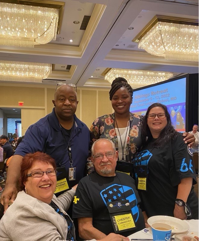 Attending a National Police Week luncheon for families and co-workers of fallen officers are (seated): Investigator Cornacchia’s parents, Dyana and Chet Cornacchia. Standing (L-R) are GTPD Investigator Chris Huggins, GTPD Sergeant Jessica Howard, and Christal Cornacchia, Investigator Cornacchia’s widow.