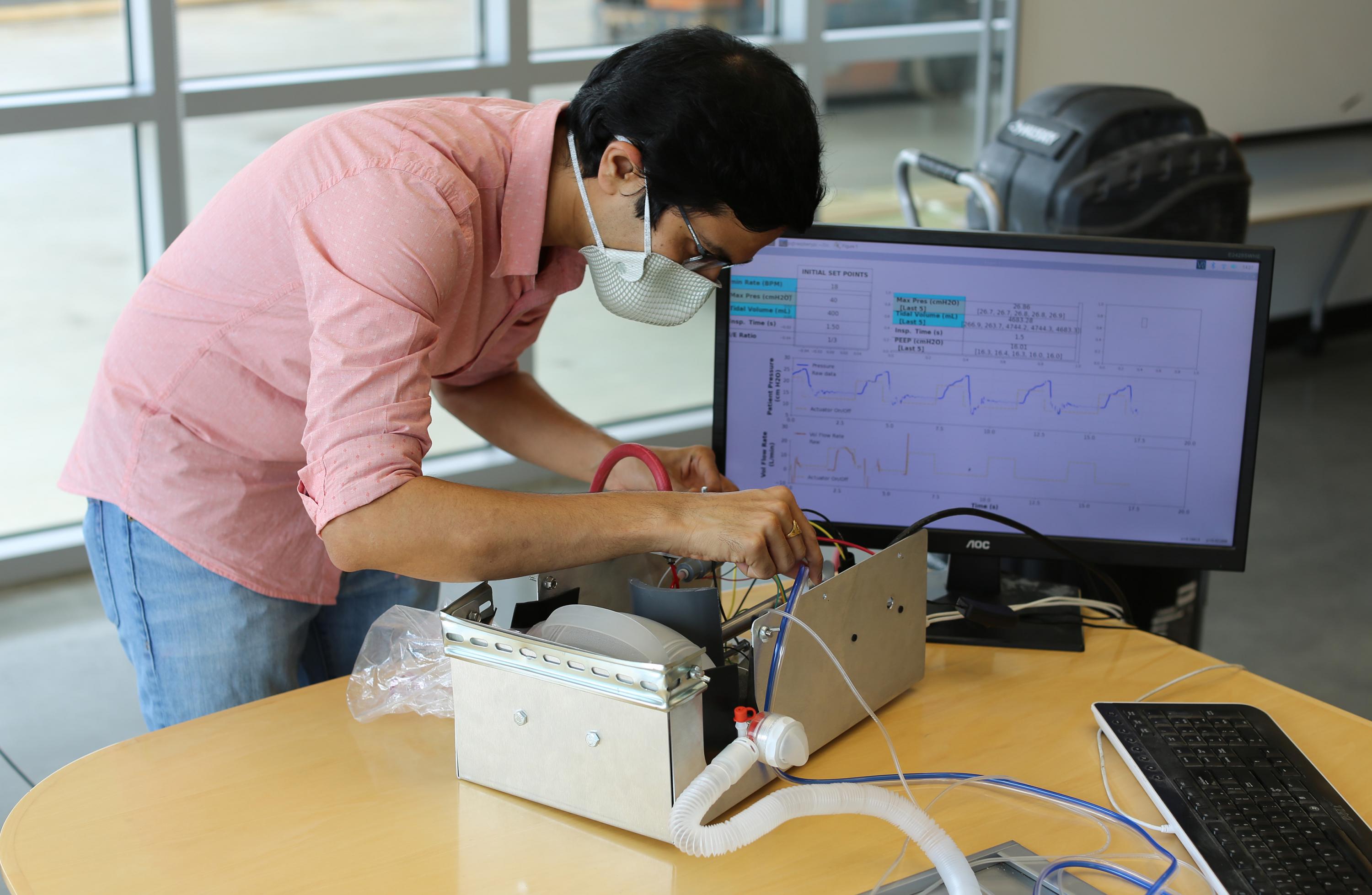 Georgia Tech Researcher Gokul Pathikonda works on the Open-AirVentGT, a low-cost, portable emergency ventilator that uses electronic sensors and computer control to manage key clinical parameters. (Credit: Ben Wright, Georgia Tech)