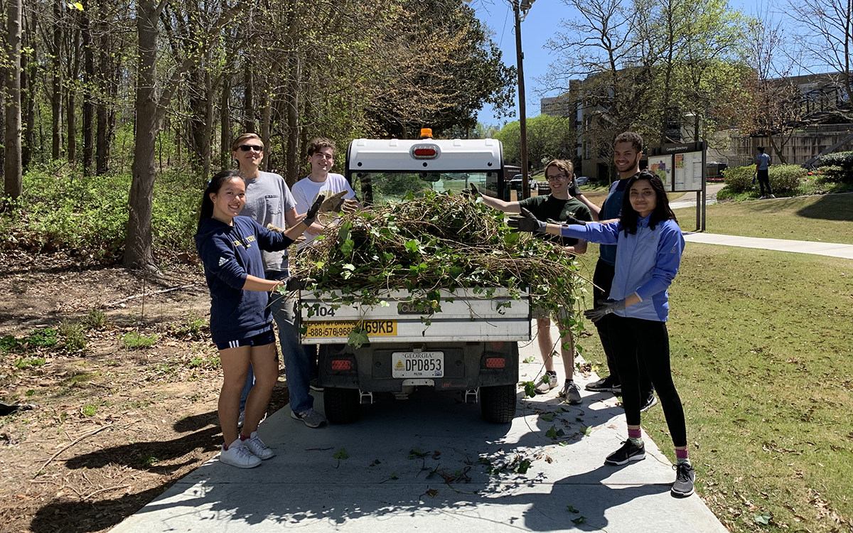 Volunteers from Students Organizing for Sustainability remove ivy from an area near The Kendeda Building for Innovative Sustainable Design in April 2022.