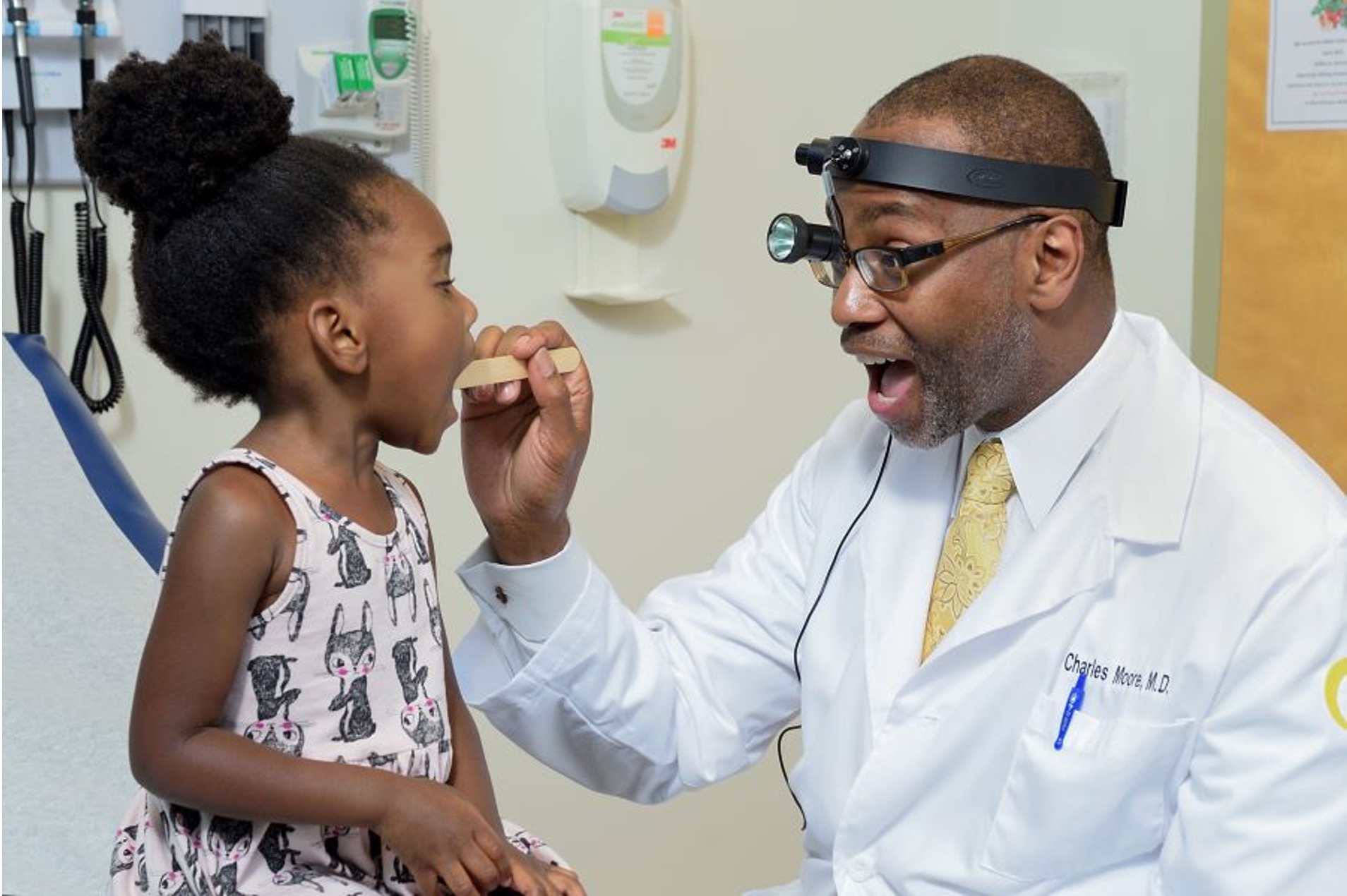 Georgia CTSA investigator Charles E. Moore, MD, professor at the Emory University School of Medicine, examines a young patient.