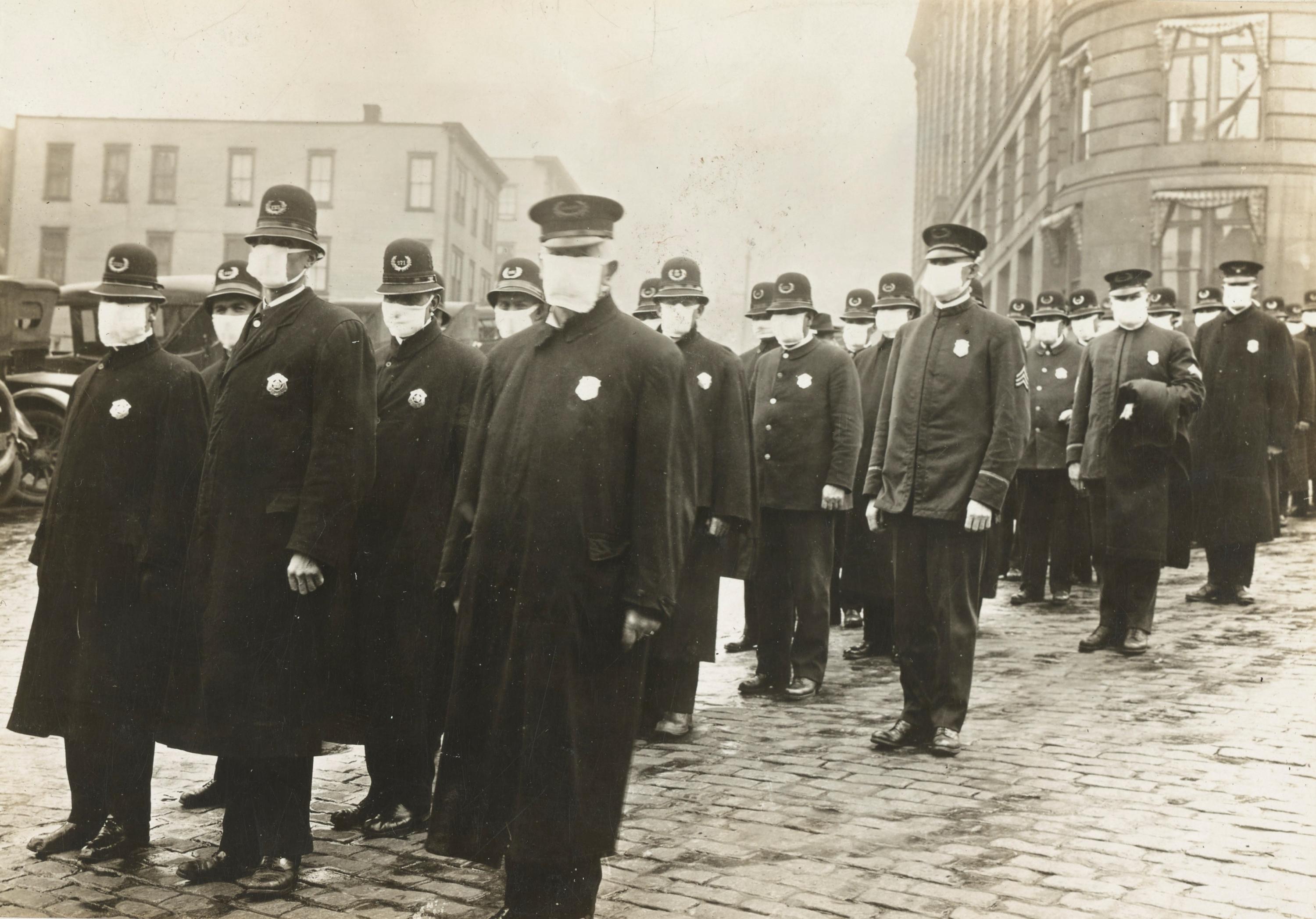Police officers in Seattle, Washington, don protective face masks during the Spanish flu pandemic. Credit: National Archives