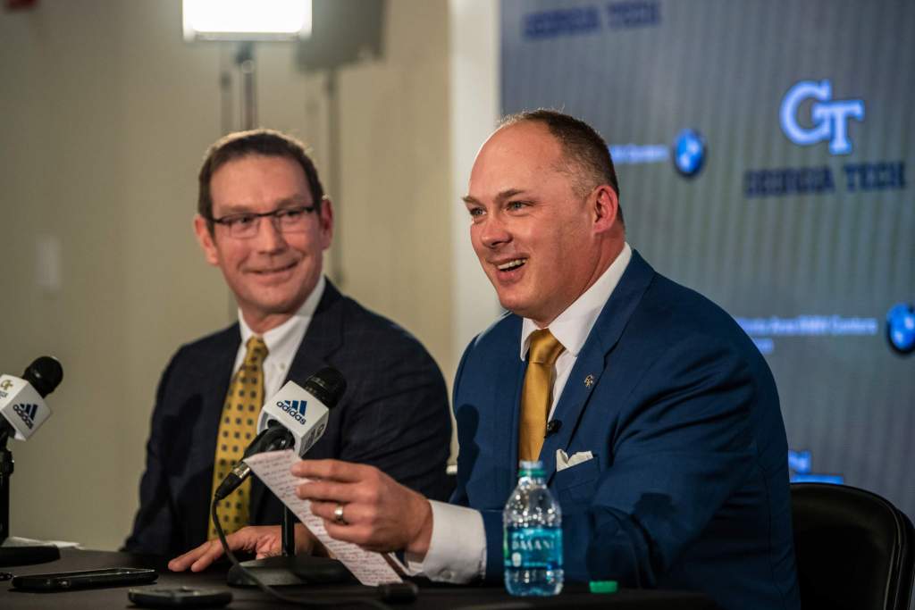 Todd Stansbury introduces Geoff Collins at a press conference on Dec. 7, 2018.