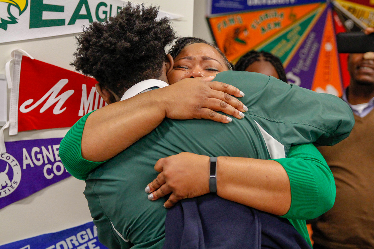 Jennifer McCrary embraces her son Chris who learned of his admission to Georgia Tech in person on Friday, Jan. 11.