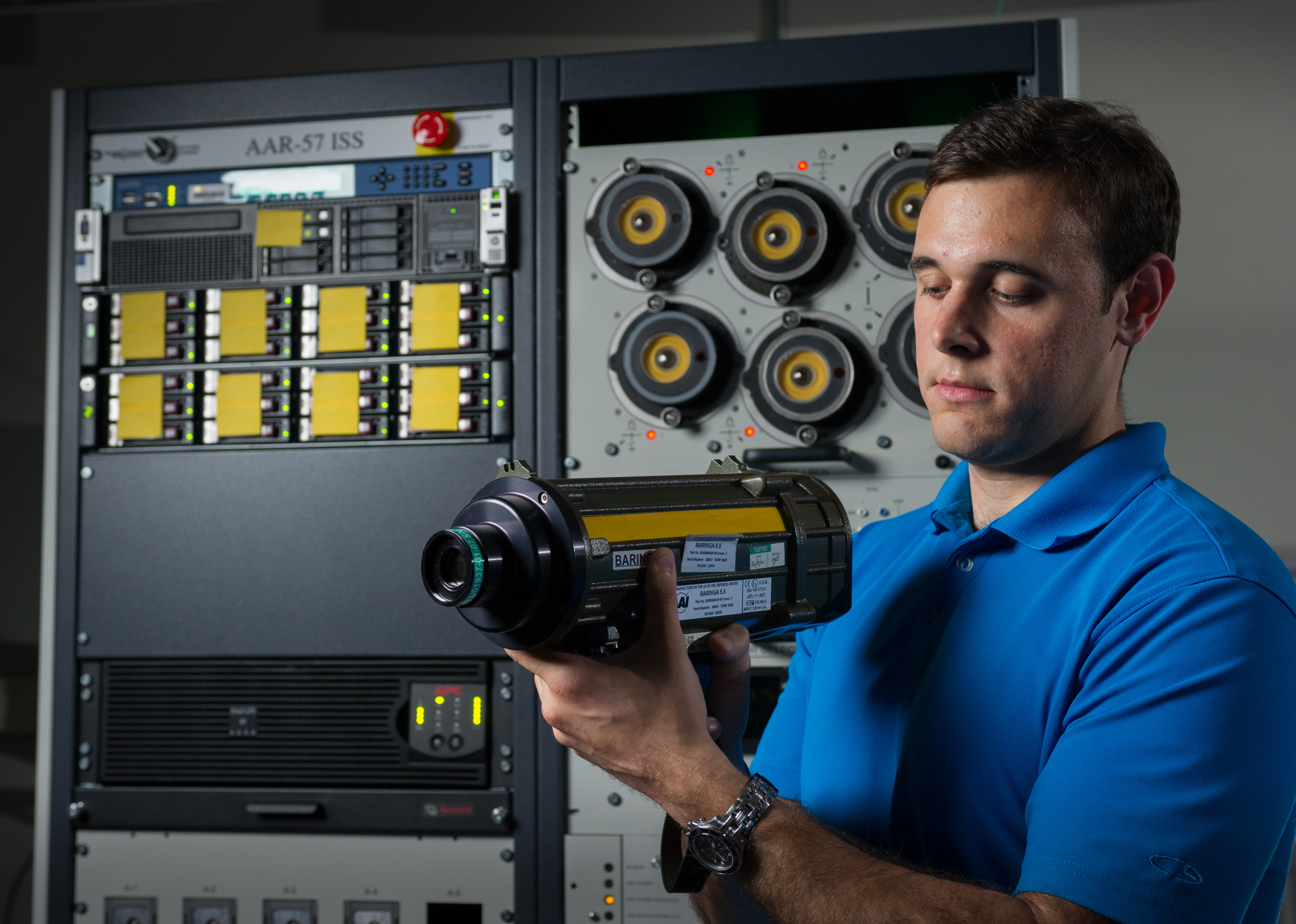 GTRI researcher Michael Coulter adjusts an instrument used to stimulate sensors that are part of the integrated support station built for testing software updates to the AN/AAR-57 Common Missile Warning System. (Photo: Rob Felt)