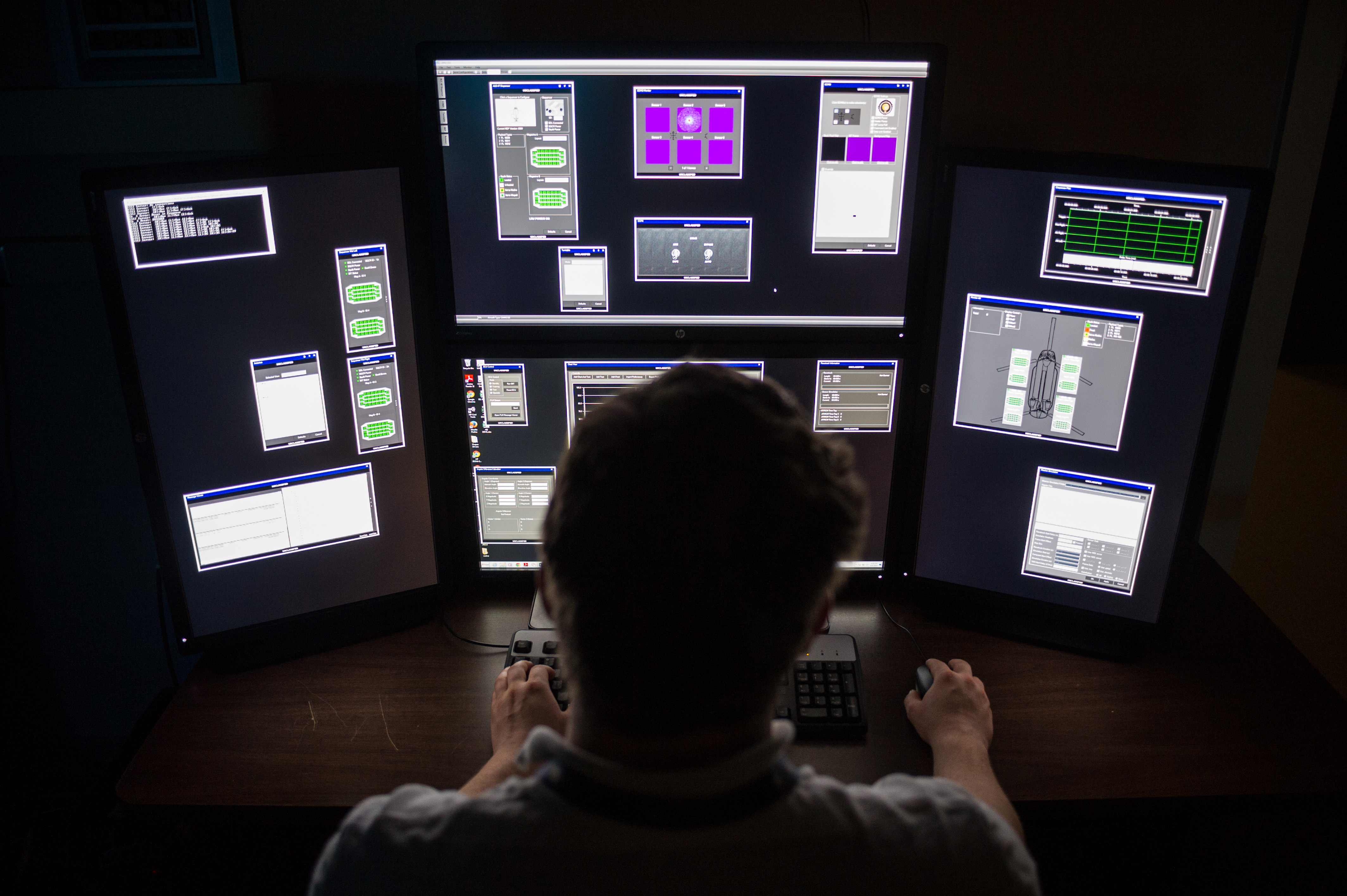 GTRI researcher Nicholas Rodine monitors testing on the screens of the AN/AAR-57 integrated support station. GTRI and the Army Reprogramming Analysis Team (ARAT) have developed and built a new ISS for testing AN/AAR-57 software updates. (Photo: Rob Felt)
