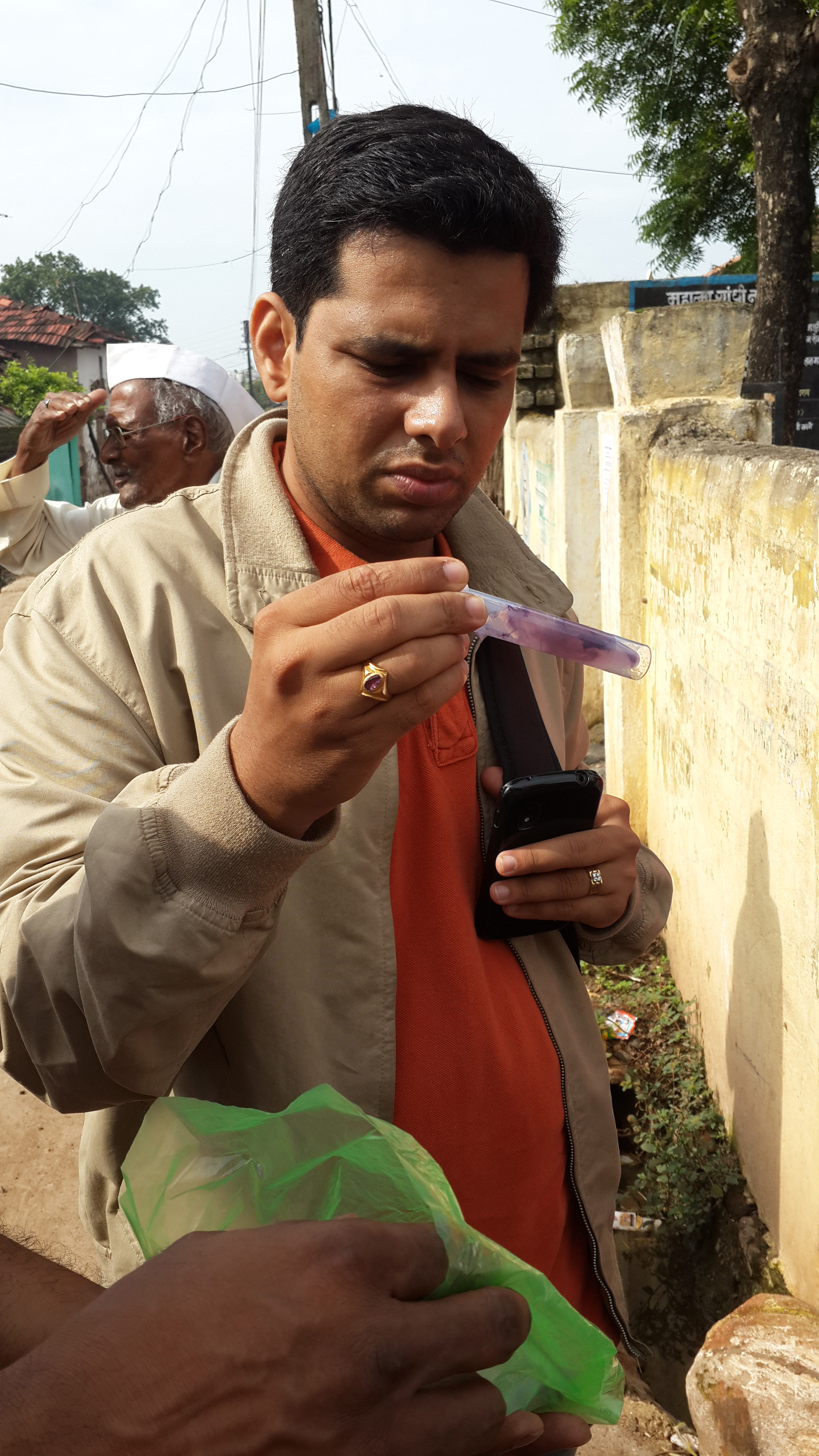 Pranav Nagarnaik of NEERI inspects a returned E. coli test kit whose color indicates the presence of bacteria. (Photo: Andy Loo)