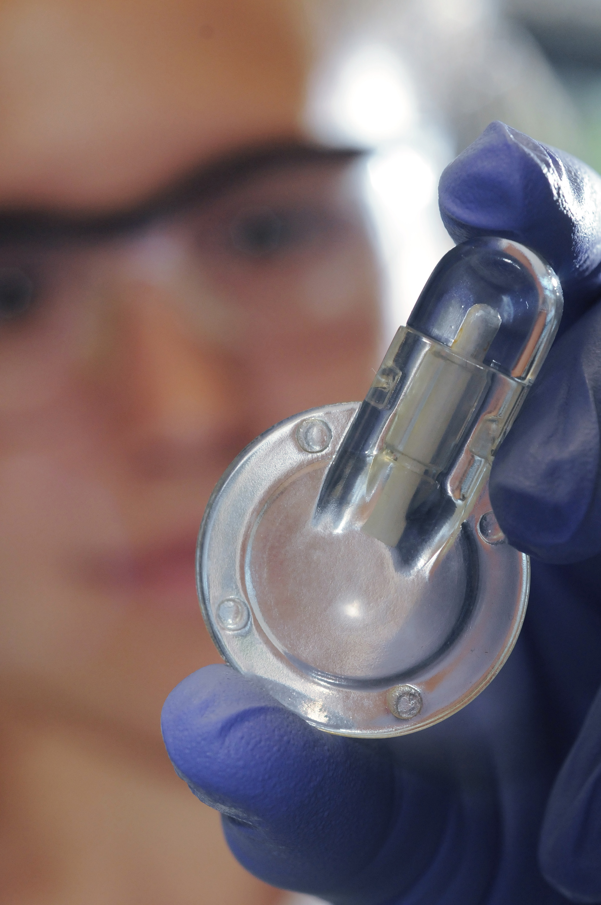 Erika Tyburski is shown with a prototype device for point-of-care testing of anemia. The device could enable more rapid diagnosis of the common blood disorder and allow inexpensive at-home self-monitoring of persons with chronic forms of the disease. (Photo: Gary Meek)