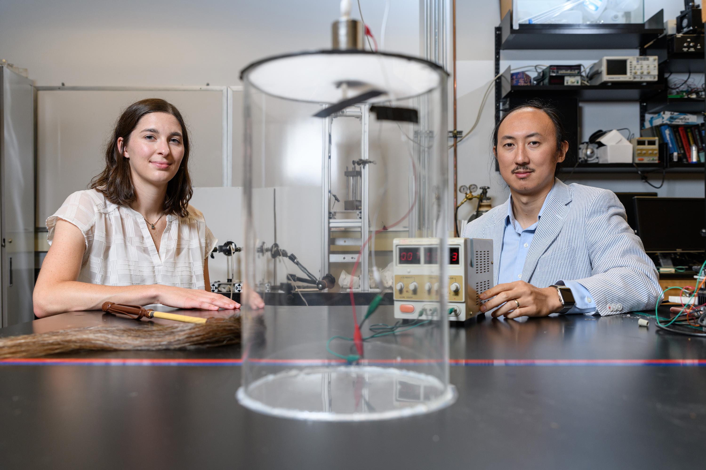Marguerite Matherne, a mechanical engineering Ph.D. student, and Professor David Hu, pose with the mammal tail simulator used to study the airflow needed to keep mosquitoes from landing. (Credit: Rob Felt, Georgia Tech)