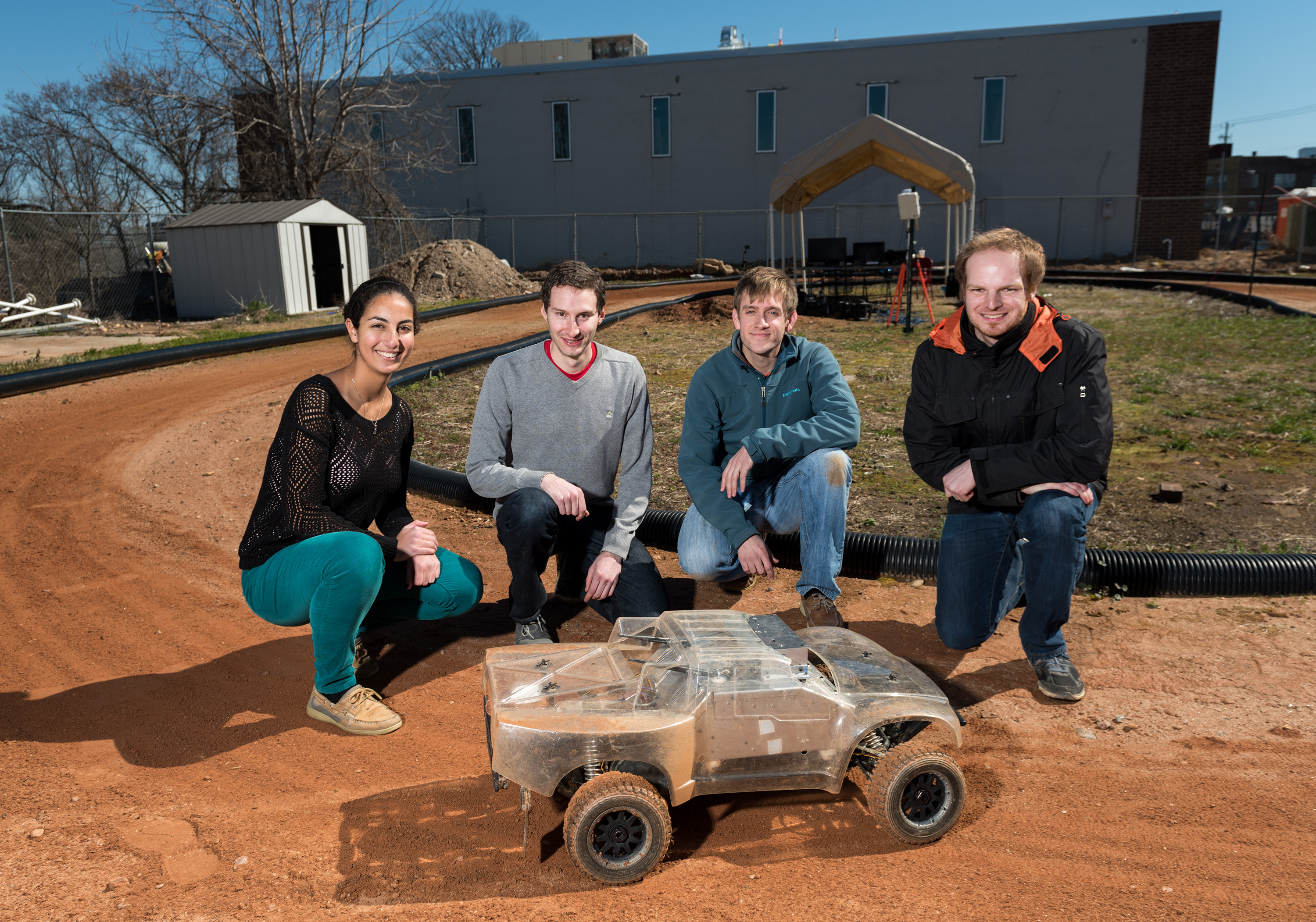 Georgia Tech researchers are using an electric-powered autonomous vehicle to help driverless vehicles maintain control at the edge of their handling limits. Shown (l-r) are Georgia Tech students Sarah Selim, Brian Goldfain, Paul Drews, Grady Williams. (Credit: rob Felt)