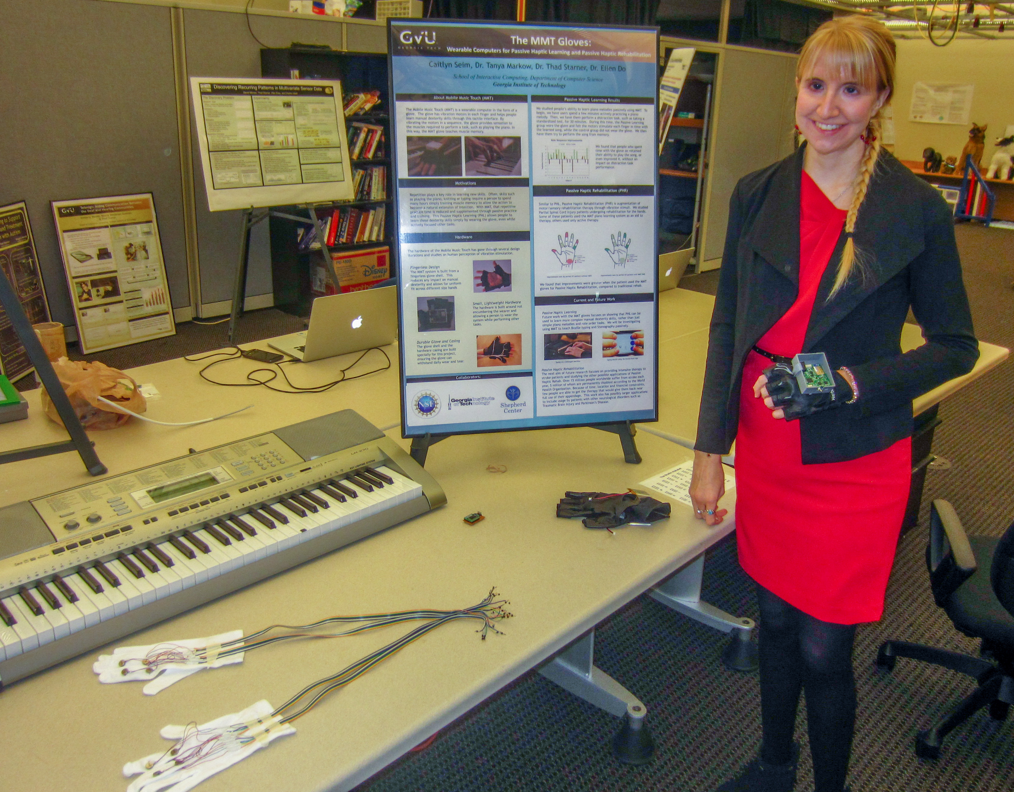 Ph.D. student Caitlyn Seim with a few iterations of the wearable computing glove technology.