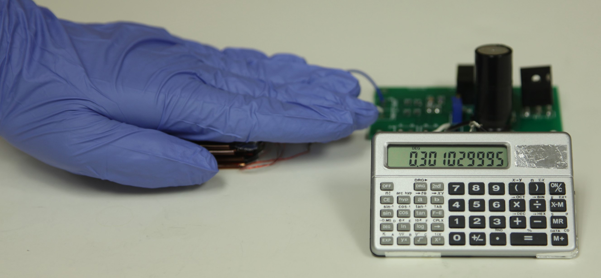 With this triboelectric nanogenerator and two-stage power management and storage system, finger tapping motion generates enough power to operate this scientific calculator. (Credit: Zhong Lin Wang Laboratory)