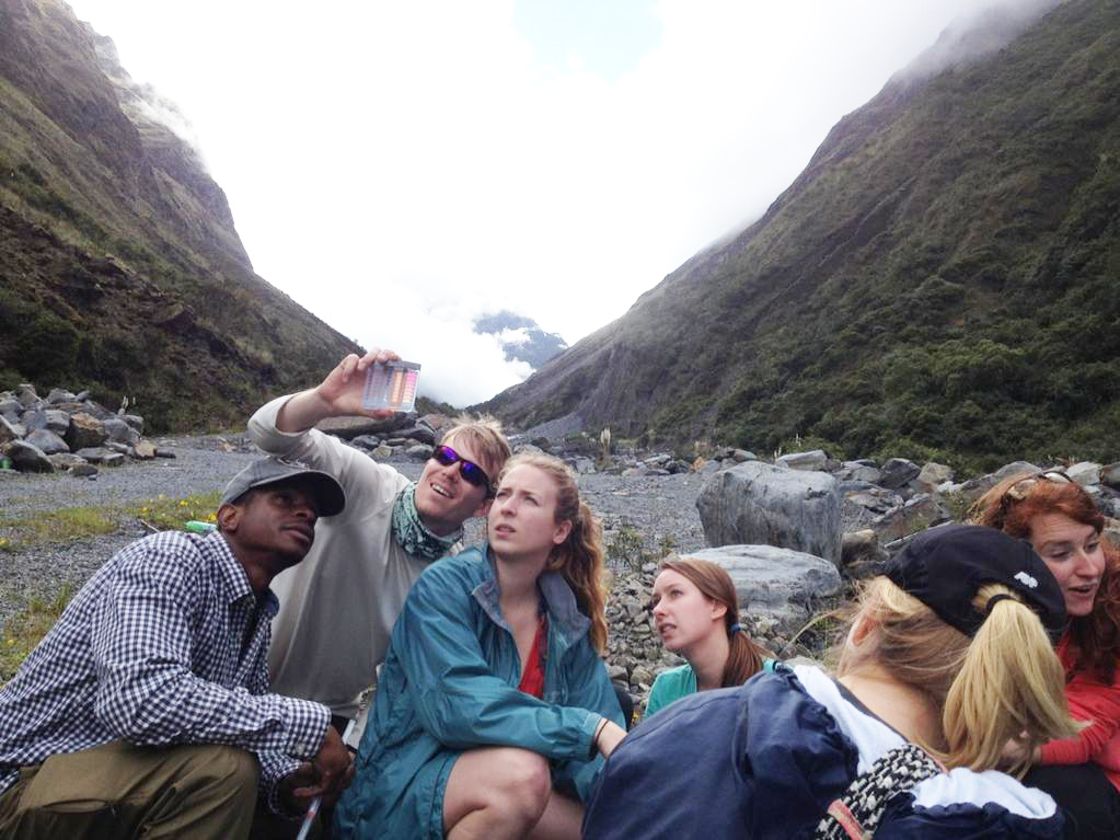 Students collect a water sample in Bolivia as part of their CEE 4803 course.