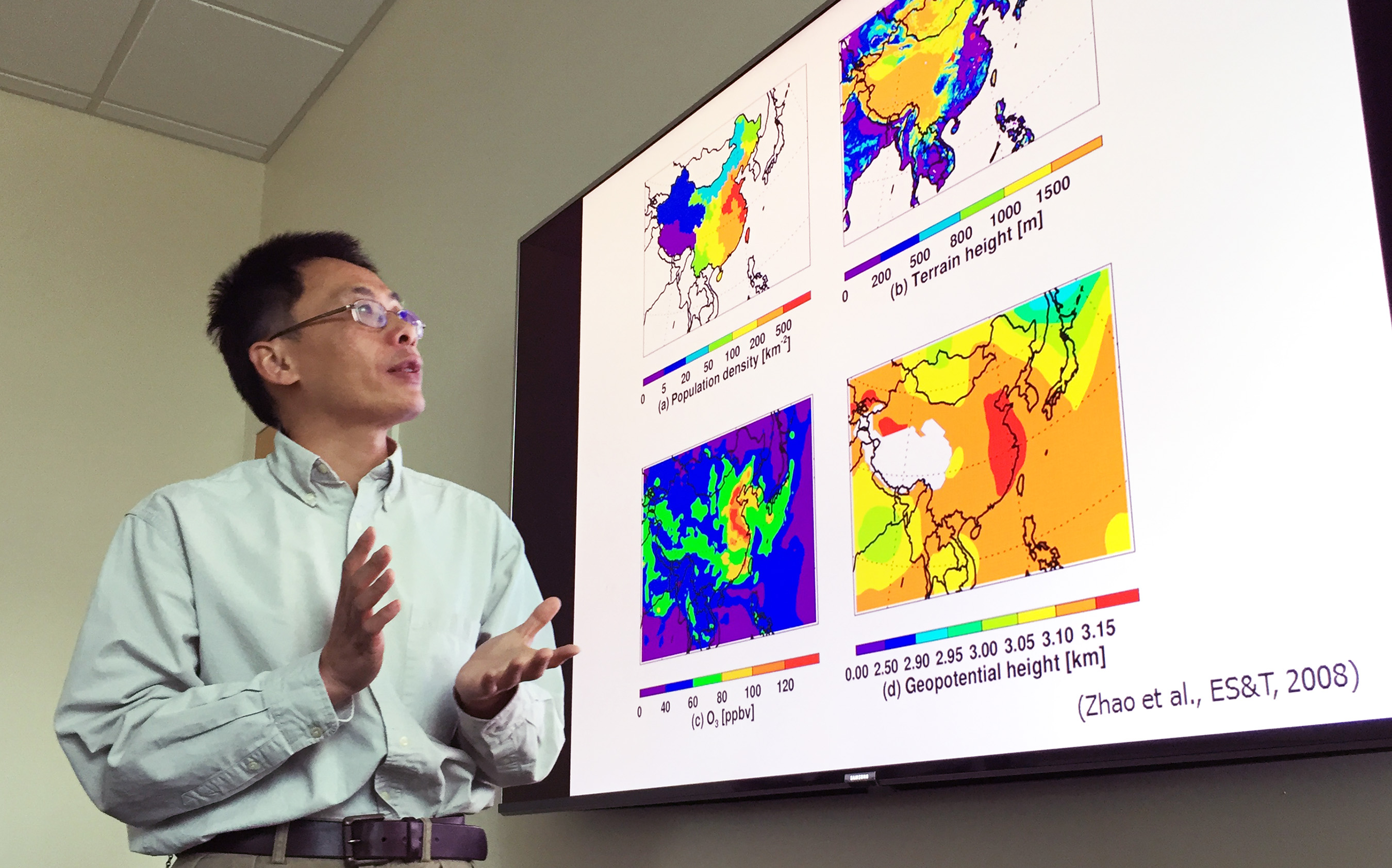 Georgia Tech Professor Yuhang Wang explains maps showing terrain, population density and other issues affecting haze formation in the East China Plains during winter months. (Credit: John Toon, Georgia Tech)