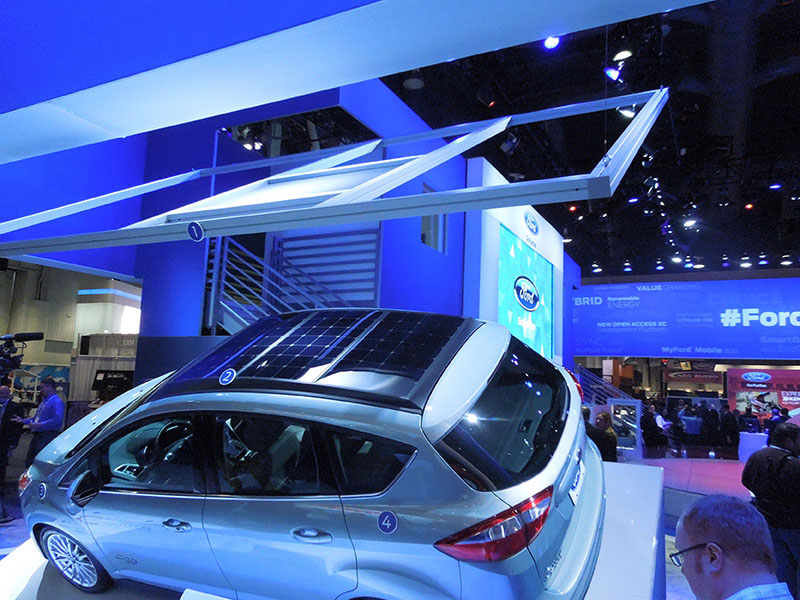 A model of the solar concentrator hangs above the C-MAX Solar Energi Concept car at the 2014 International CES in Las Vegas. Credit: Bert Bras.