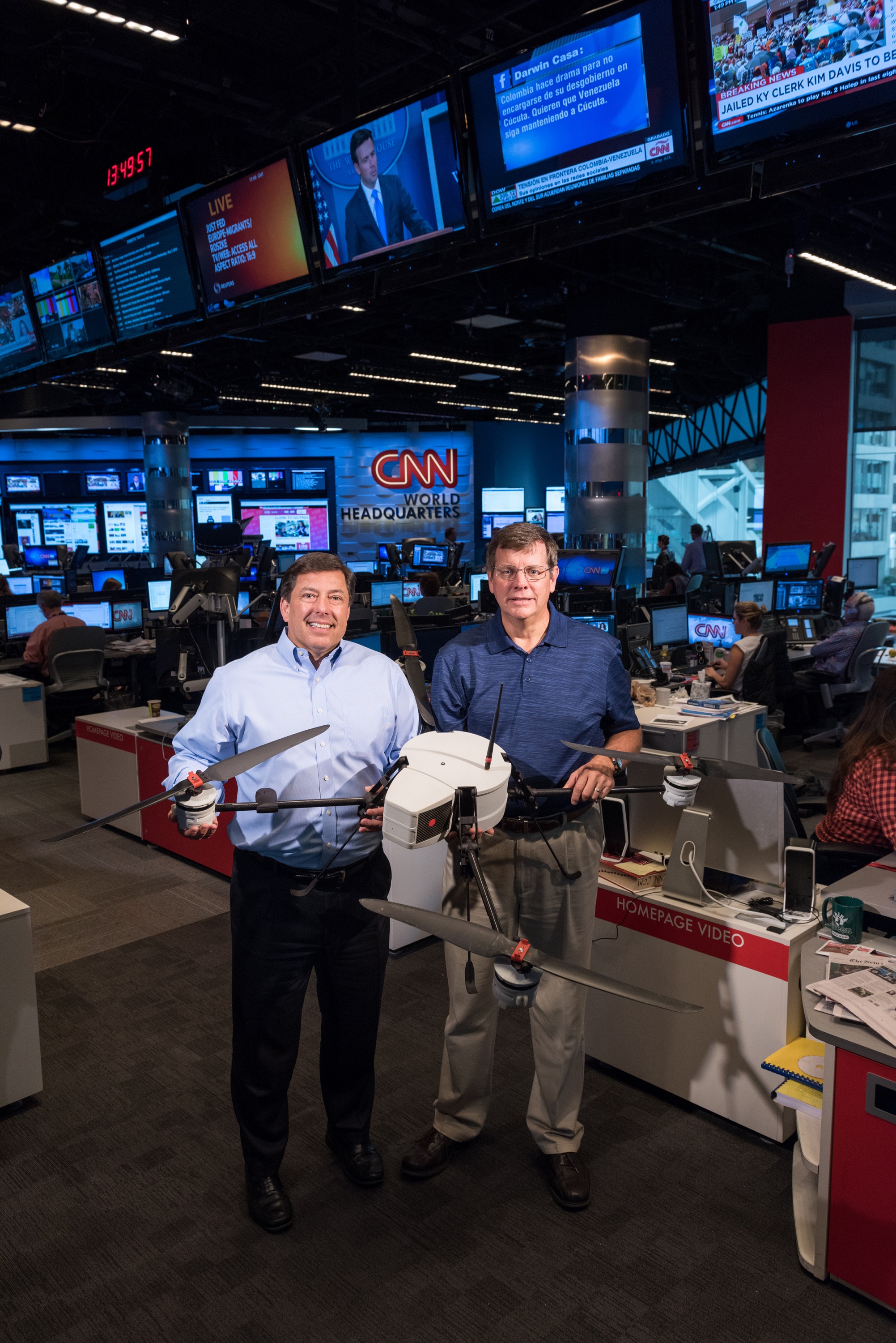 The Georgia Tech Research Institute (GTRI) and CNN have been working together to study the issues affecting the use of unmanned aerial vehicles for newsgathering. Shown in CNN’s World Headquarters are (left) Greg Agvent, senior director of news operations for CNN, and Cliff Eckert, a GTRI senior research associate who’s working on the project. They are shown with an AirRobot AR 180, one of the devices that may be suitable for newsgathering. (Credit: Rob Felt, Georgia Tech)