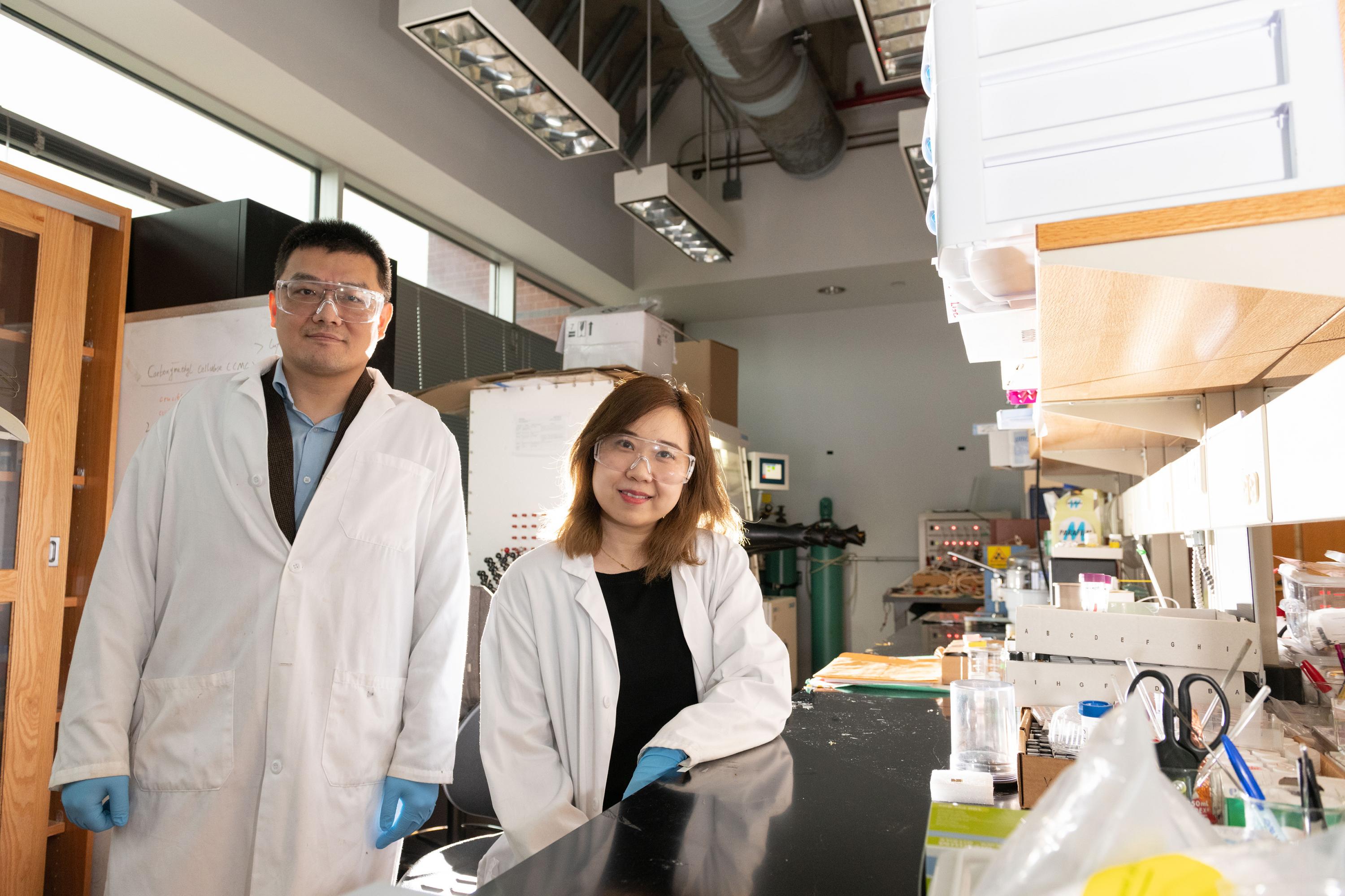 Hailong Chen, an assistant professor in the George W. Woodruff School of Mechanical Engineering, and Xuetian Ma, a graduate research assistant, are shown in their laboratory. The researchers determined for the first time what controls formation of two different nanoscale crystalline structures in the metal cobalt. (Credit: Allison Carter, Georgia Tech)