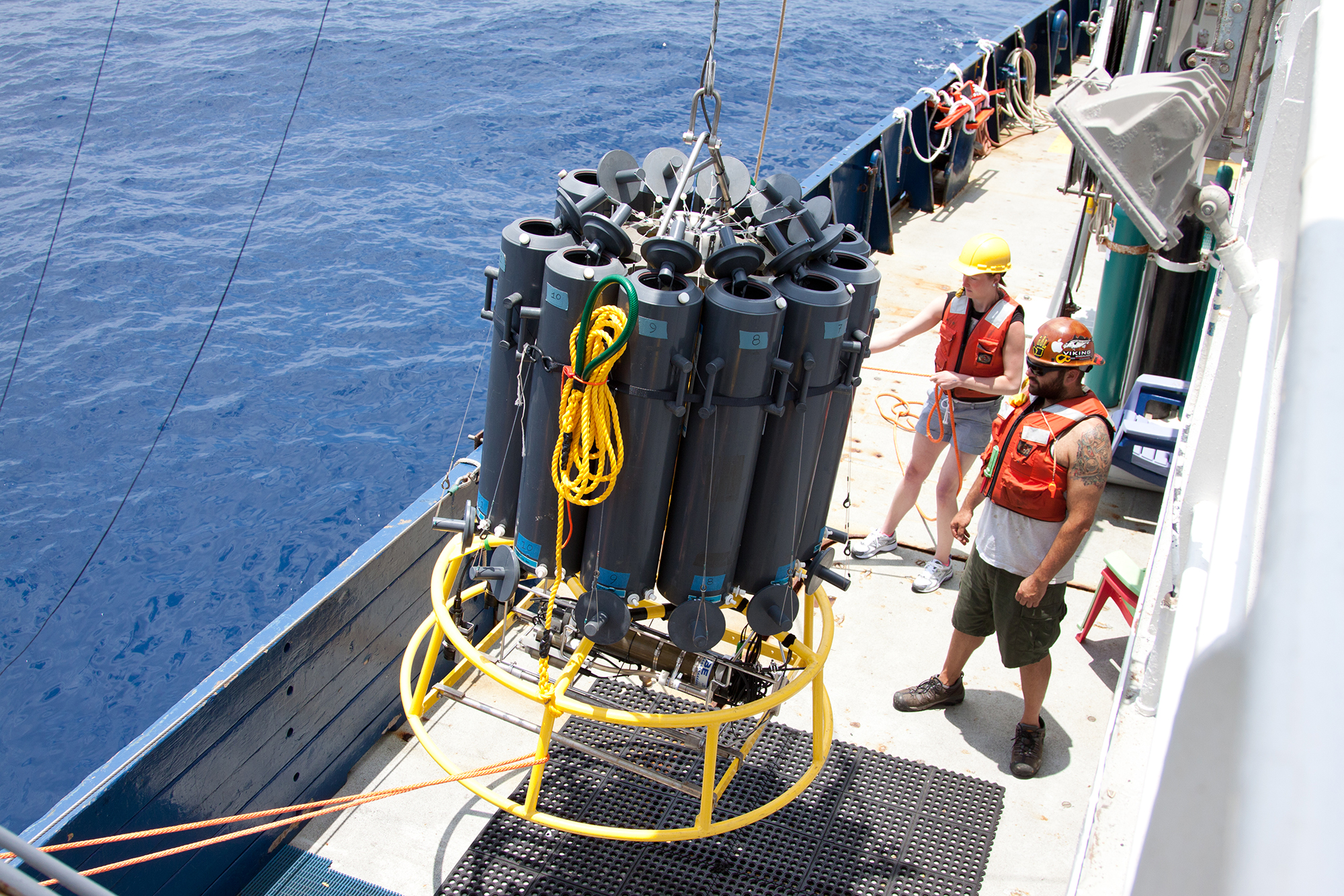 Researchers Liz Robertson from the University of Southern Denmark and Josh Manger from the University of California, San Diego, ready a sample collector. The carrousel of tubes dropped down 1,000 feet to an oxygen minimum zone off Mexico's Pacific coast. Credit: Dr. Heather Olins