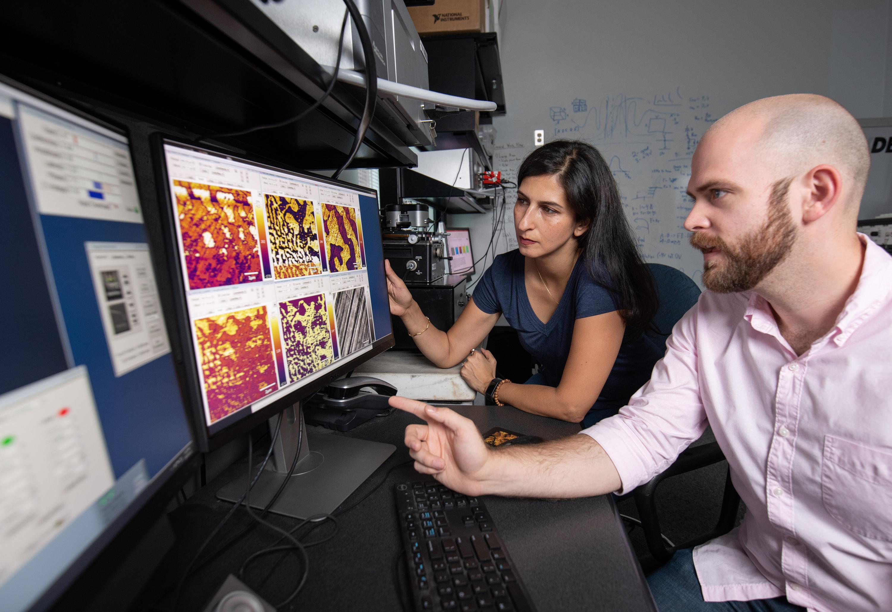 Professor Nazanin Bassiri-Gharb and Ph.D. Candidate Lee Griffin discuss the electromechanical amplitude response of a single crystal as acquired by a modified atomic force microscope (i.e., a piezoresponse force microscope). (Photo: Rob Felt, Georgia Tech)