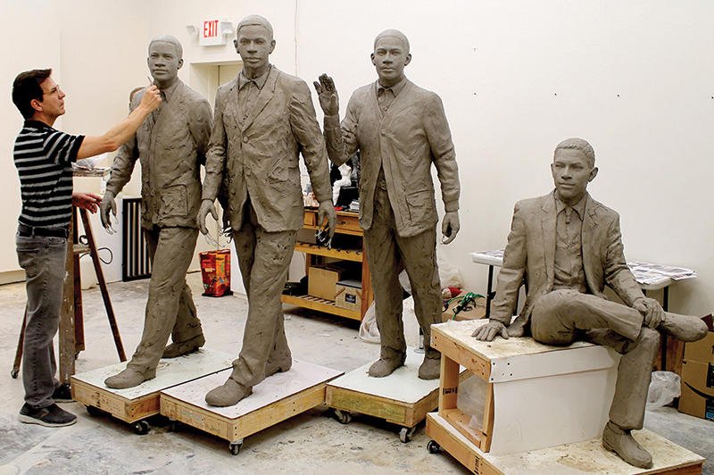 Martin Dawe in his studio working on the The Three Pioneers and The First Graduate