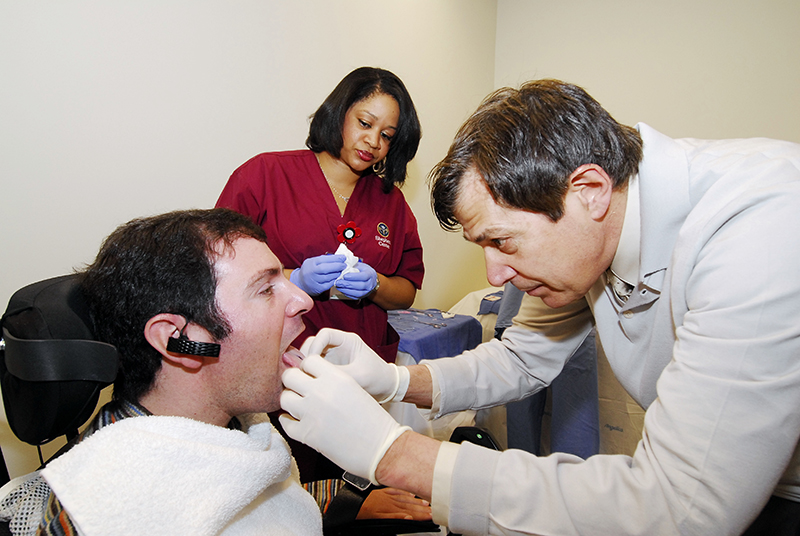 Jason DiSanto receives a tongue piercing so he can test the Tongue Drive System. Credit: Shepherd Center