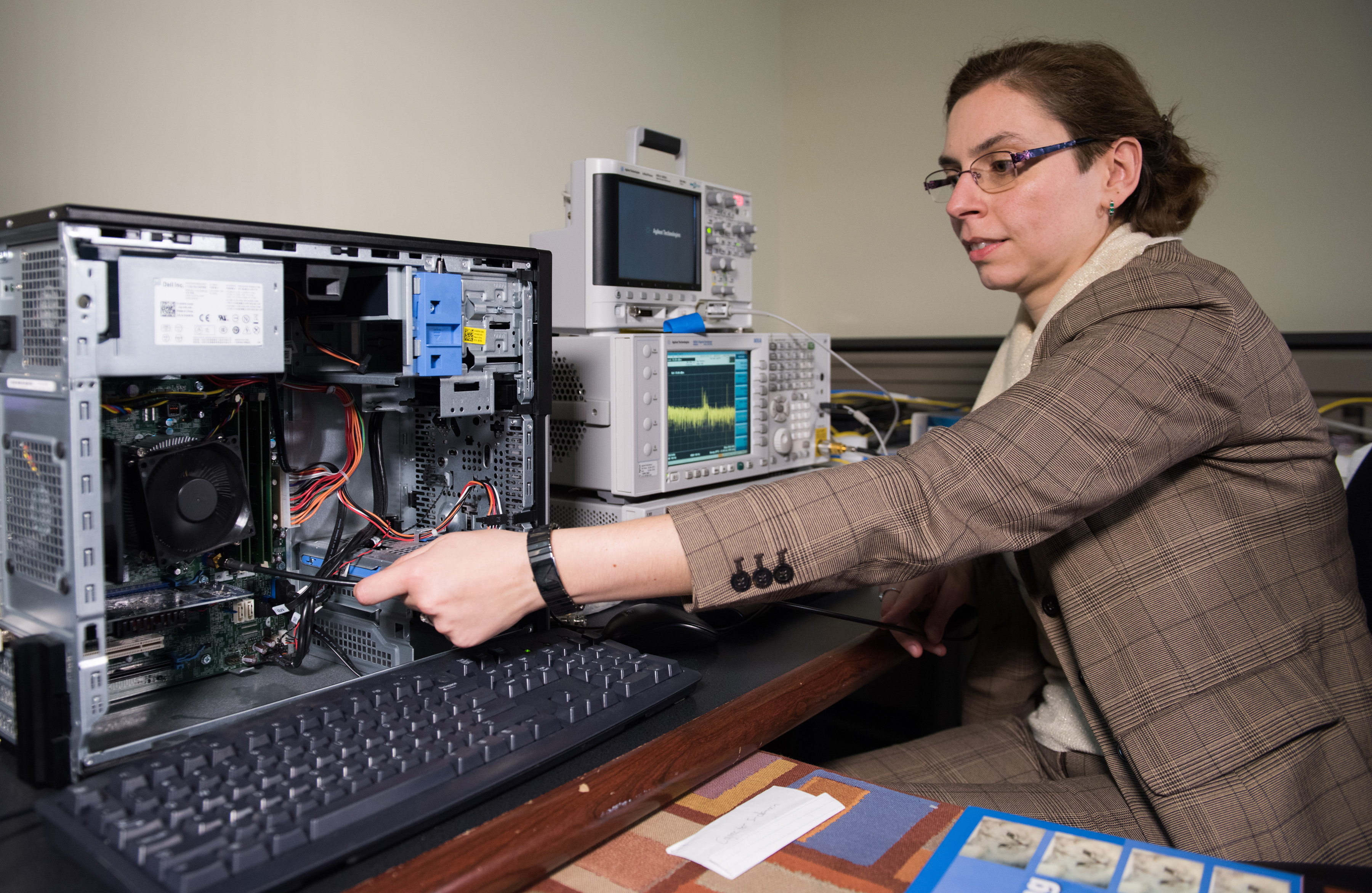 Georgia Tech researcher Alenka Zajic measures electromagnetic emissions from various components of a desktop computer. The researchers have studied emissions from desktop and laptop computers, as well as cellphones. (Credit: Rob Felt)