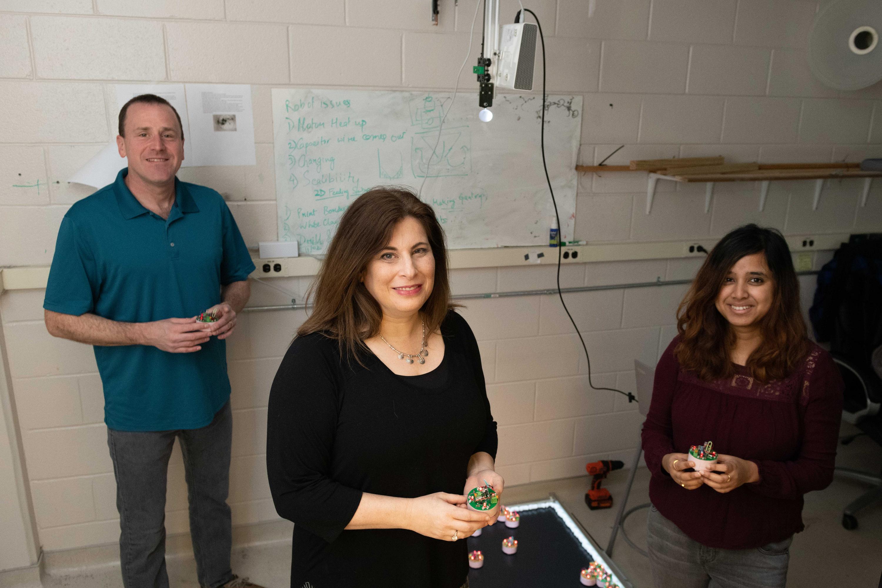 Researchers at the Georgia Institute of Technology have been awarded $6.25 million to use collective emergent behavior to achieve task-oriented objectives. Shown are Dan Goldman, professor in the School of Physics; Dana Randall, co-director of the Institute for Data Engineering and Science, and Ph.D. student Bahnisikha Dutta. (Photo: Allison Carter, Georgia Tech)