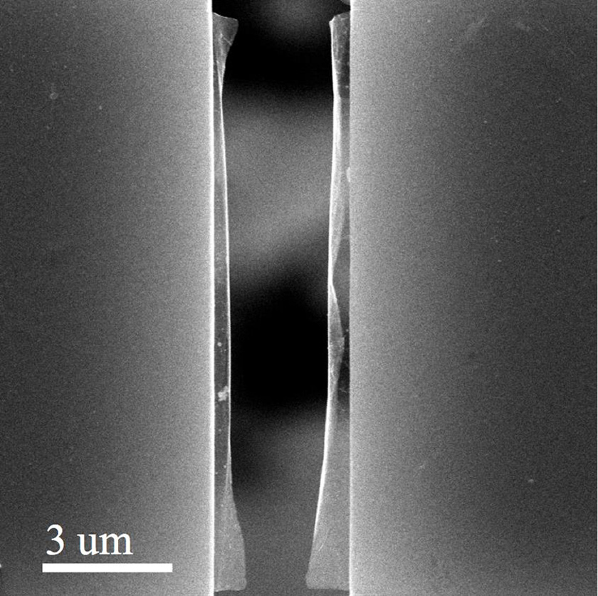 A pre-cracked sheet of graphene was suspended and pulled apart on a spring-loaded stage to measure how much strength a defective piece of graphene shows. Scientists at Rice University and Georgia Tech found graphene is only as strong as its weakest point. Because most graphene has defects, its real strength is likely to be significantly lower than the intrinsic strength of a perfect sheet of the atom-thick carbon material. (Credit: The Nanomaterials, Nanomechanics and Nanodevices Lab/Rice University)