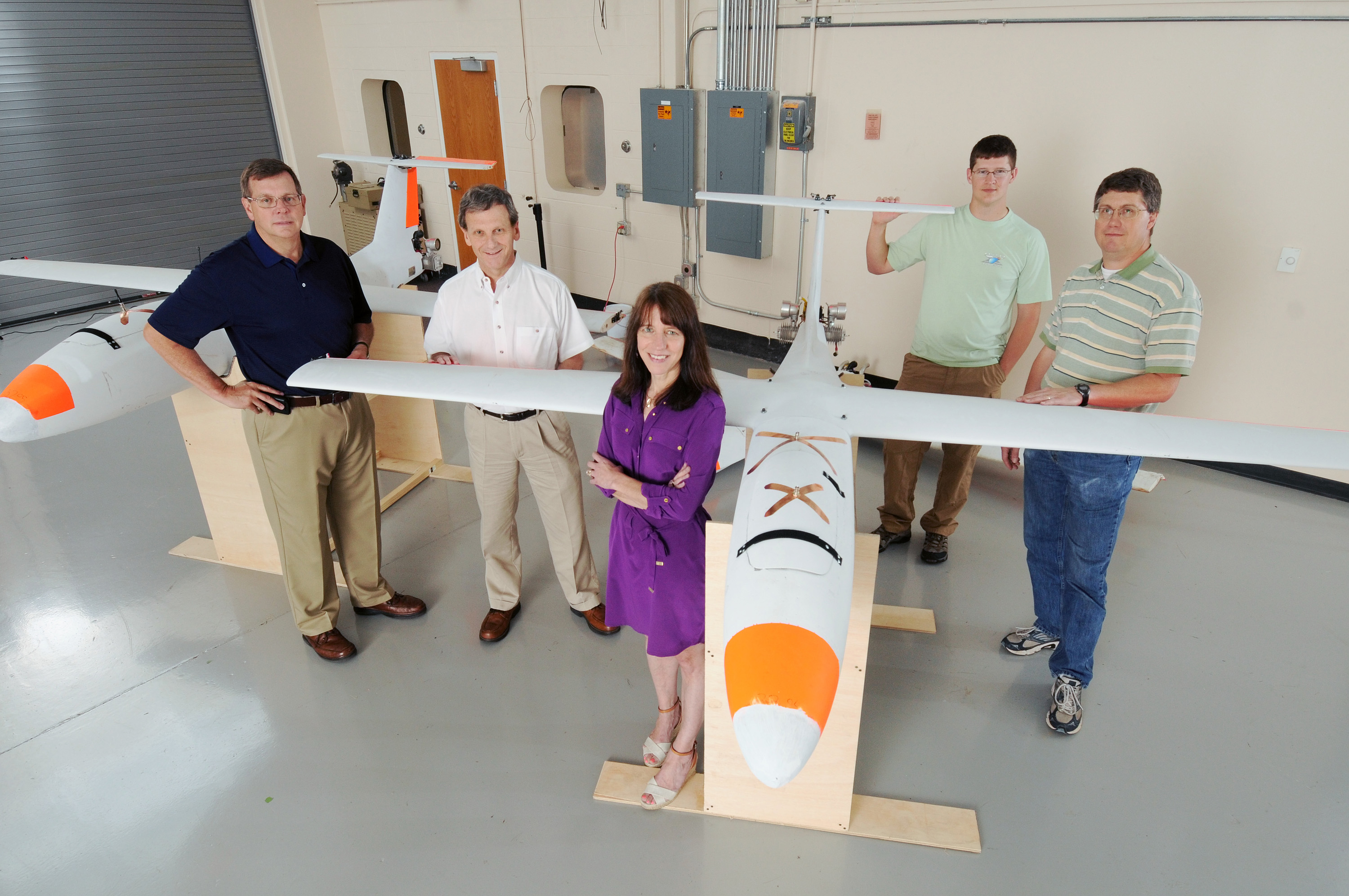GTRI researchers are shown with two unmanned aerial vehicles used in their research program. The researchers are (l-r) Cliff Eckert, Don Davis, Lora Weiss, Kyle Carnahan and Gary Gray. (Photo: Gary Meek)