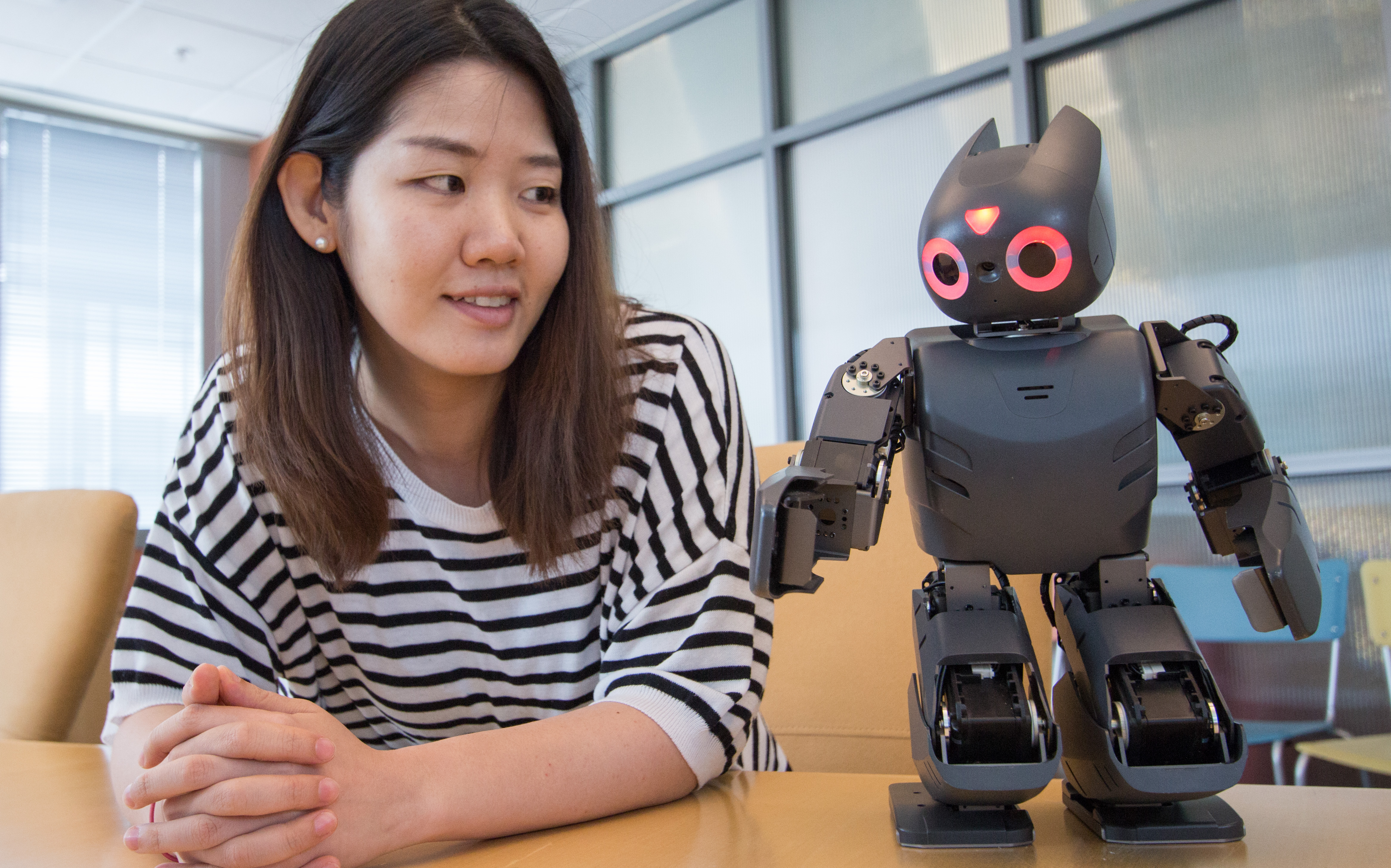 Postdoctoral fellow Hae Won Park (ECE) interacts with robot that can be programmed to learn new skills, including Angry Birds
