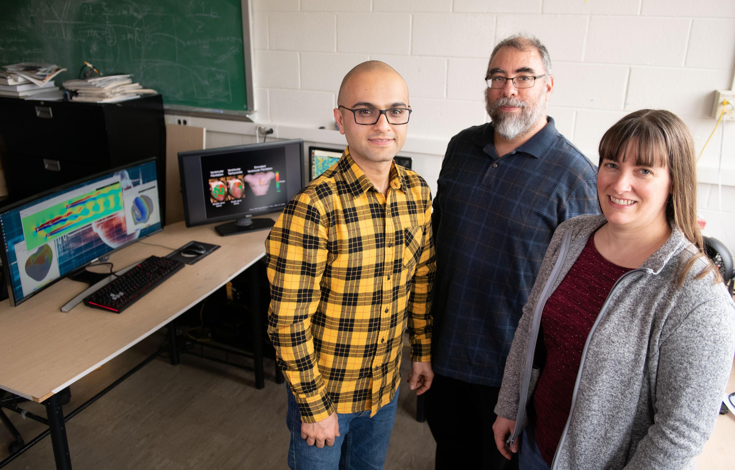 Researchers have developed a system that uses graphics processing chips designed for gaming applications and software that runs on ordinary web browsers to produce simulations that formerly required high-powered computers. Shown are Abouzar Kaboudian, Flavio Fenton and Elizabeth Cherry. (Photo: Allison Carter, Georgia Tech)