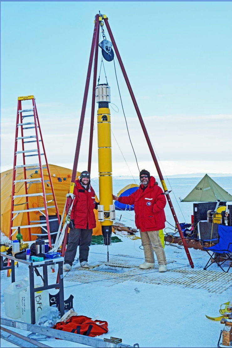 A robotic submarine outfitted to probe for signs of life is lowered under the ice in Antarctica. In the future, a highly updated version could be placed on a rocket for deployment in under-ice oceans on planetary neighbors in our solar system. Credit: Georgia Tech