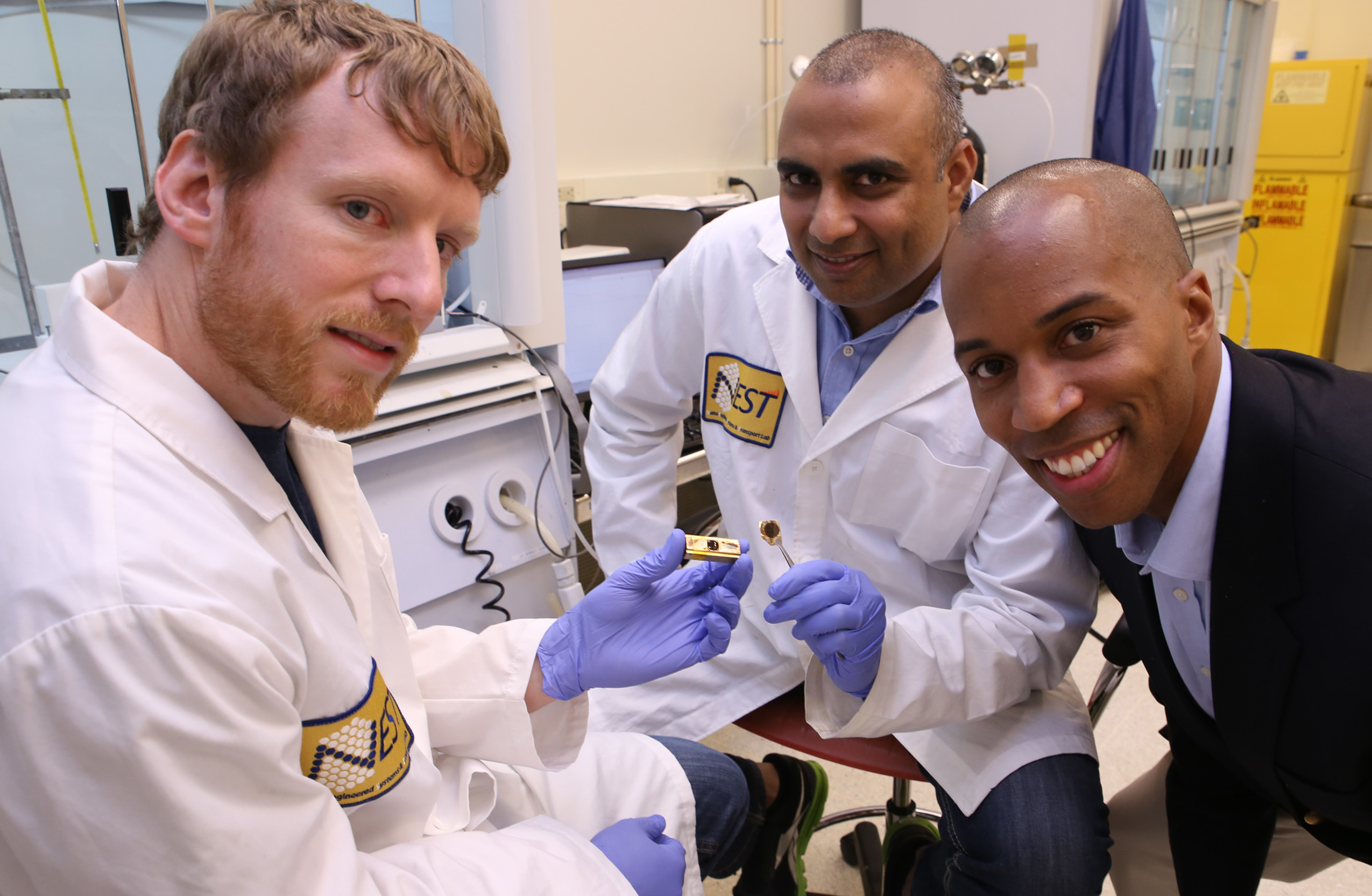 Georgia Tech researchers have developed a polymer material that can reliably conduct heat from electronic devices. Shown (l-r) are Thomas Bougher, a Ph.D. student in the George W. Woodruff School of Mechanical Engineering, Virendra Singh, a research scientist in the Woodruff School, and Baratunde Cola, an assistant professor. (Georgia Tech Photo: Candler Hobbs)