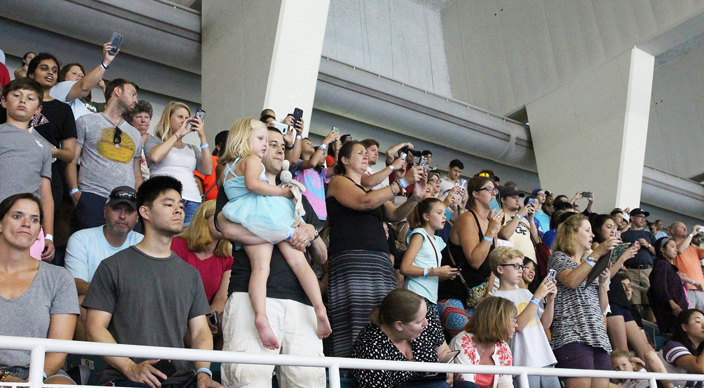 Fans snap photos of Olympic swimmers Michael Phelps and Ryan Lochte during an open training session on July 30, 2016.