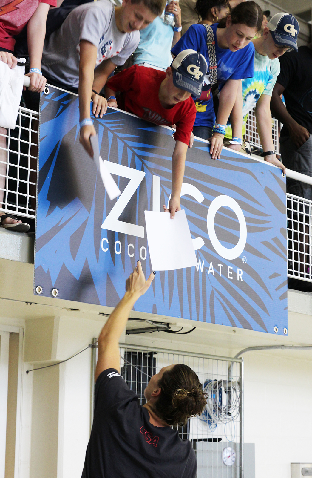 Amanda Weir signs an autograph for a young fan at an open practice session at Georgia Tech's McAuley Aquatic Center on July 30, 2016