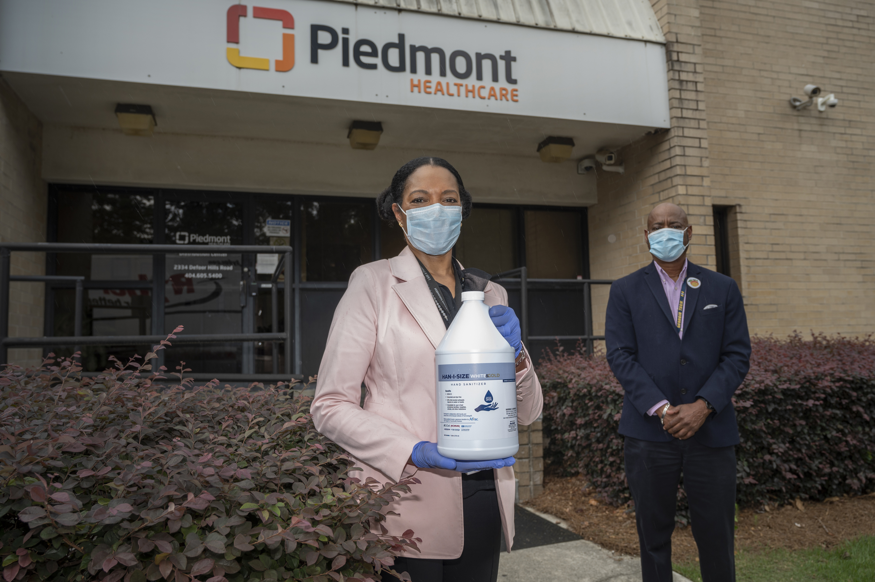 Dr. Jayne Morgan welcomes the first delivery of the newly designed, ethanol-based hand sanitizer to Piedmont Healthcare of Atlanta. Behind her, George White of Georgia Tech, a team member in the hand sanitizer initiative. Georgia Tech / Christopher Moore