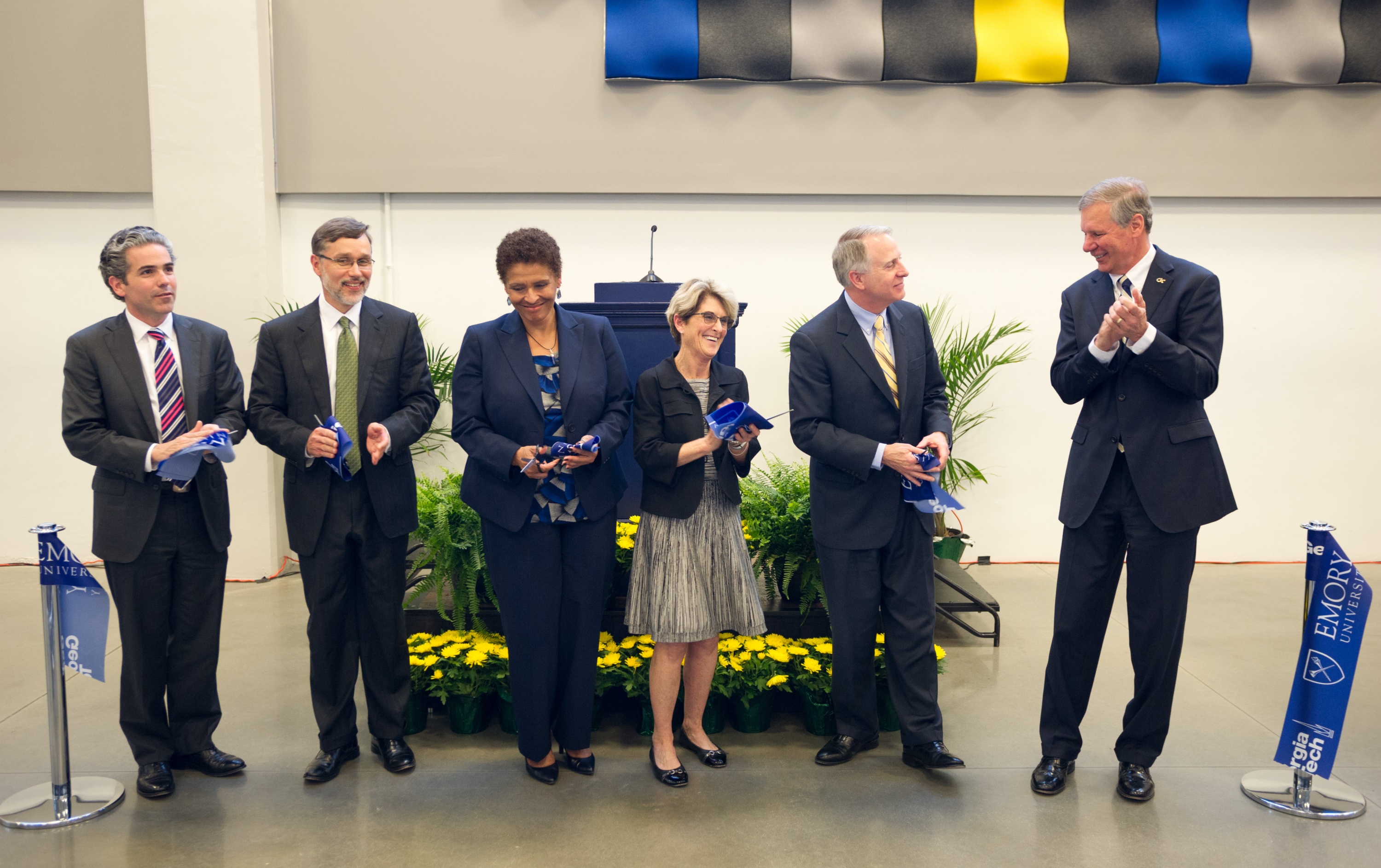 On hand to cut the ribbon for the new Library Service Center shared by Georgia Tech and Emory are, from left, Jack Tillman, President of EmTech; Rich Mendola, senior vice provost of Library Services &amp; Digital Scholarship at Emory; Yolanda Cooper, Emory University librarian; Catherine Murray-Rust, vice provost for learning excellence and dean of libraries at Georgia Tech; Emory President James Wagner; and Georgia Tech President G.P. "Bud" Peterson.